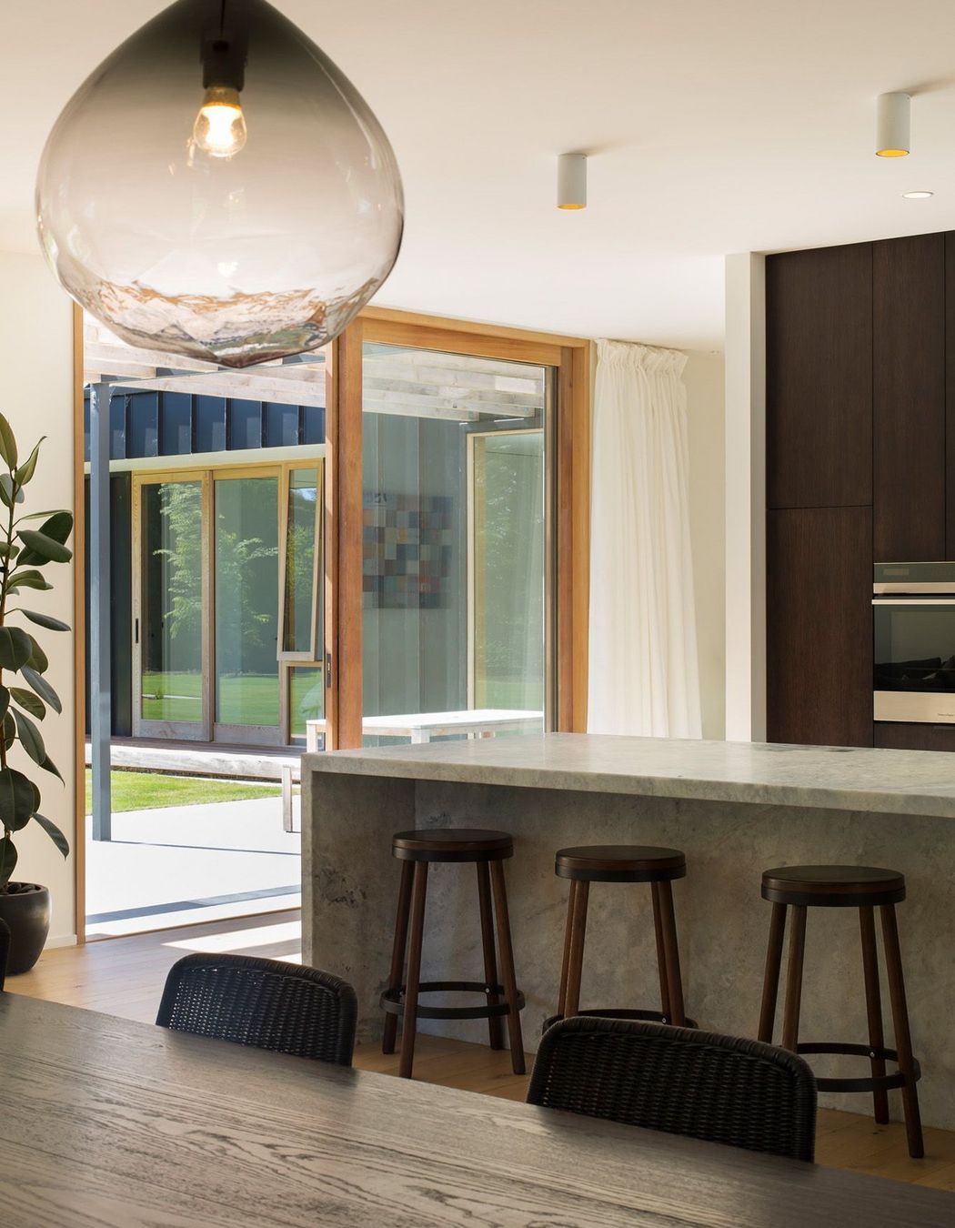 The kichen and dining area leads out into the pergola-covered courtyard.