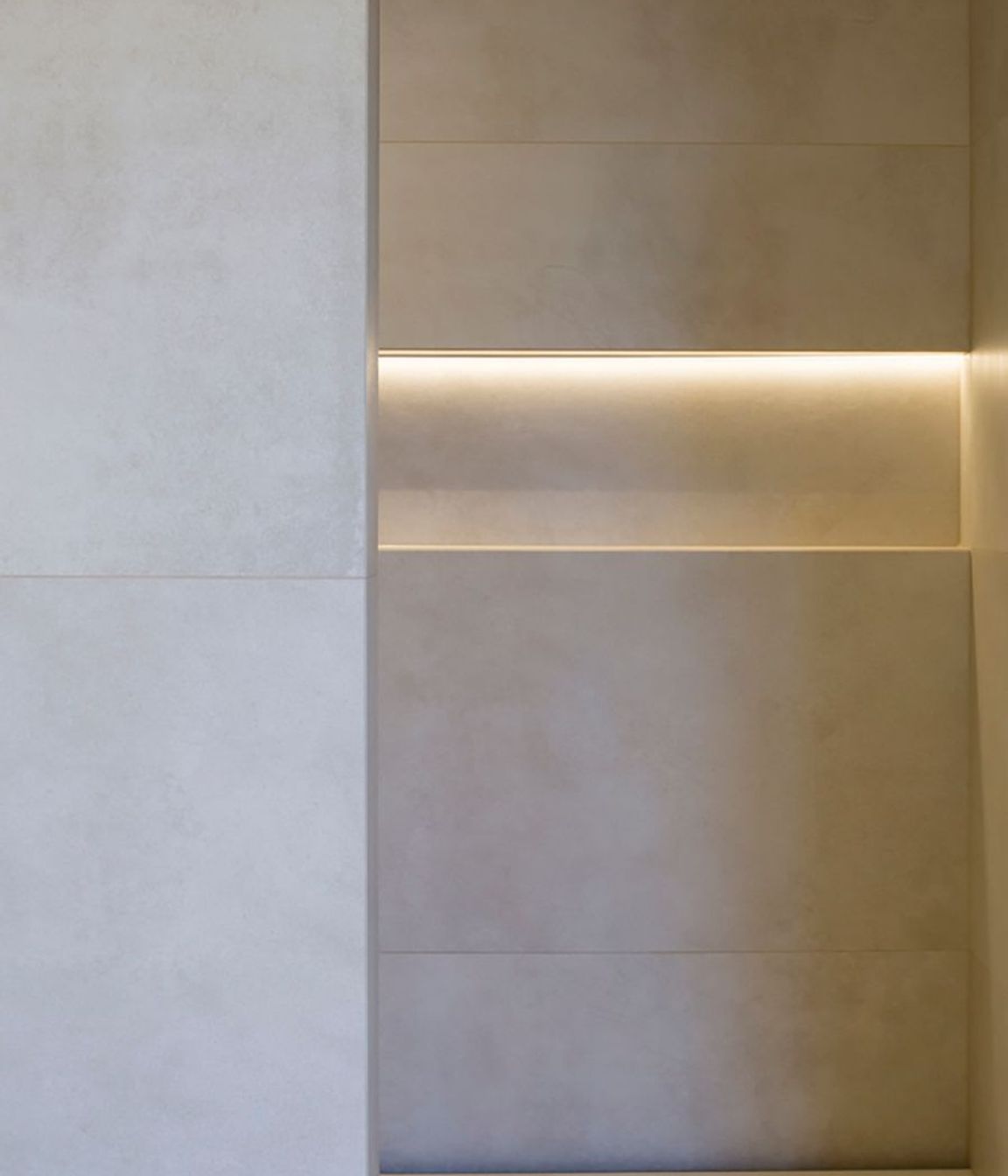 Subtle downlighting emphasises the patterns in the tiling.