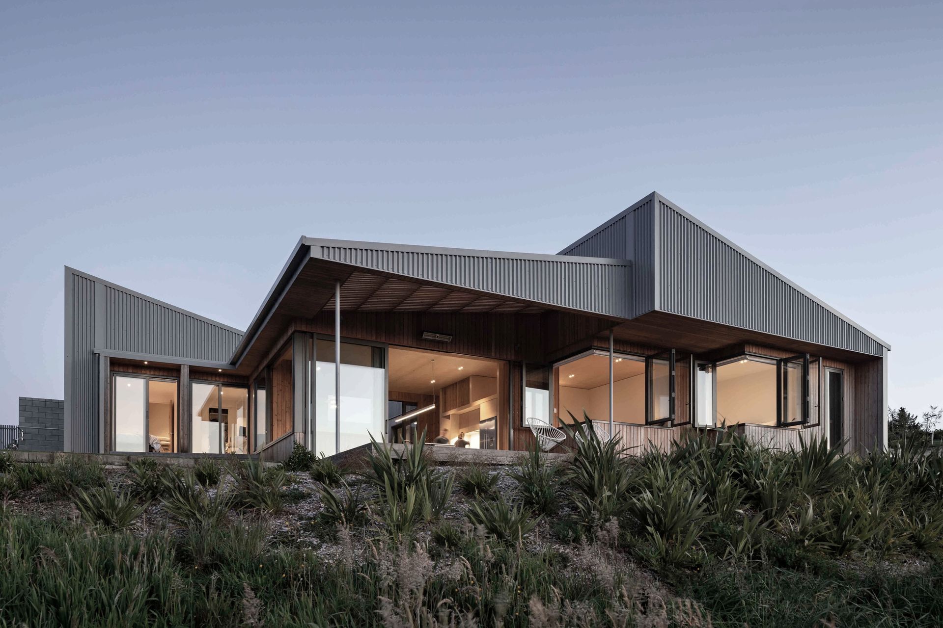 The exterior materiality features a corrugated cladding that ties into the rural typology of the home.