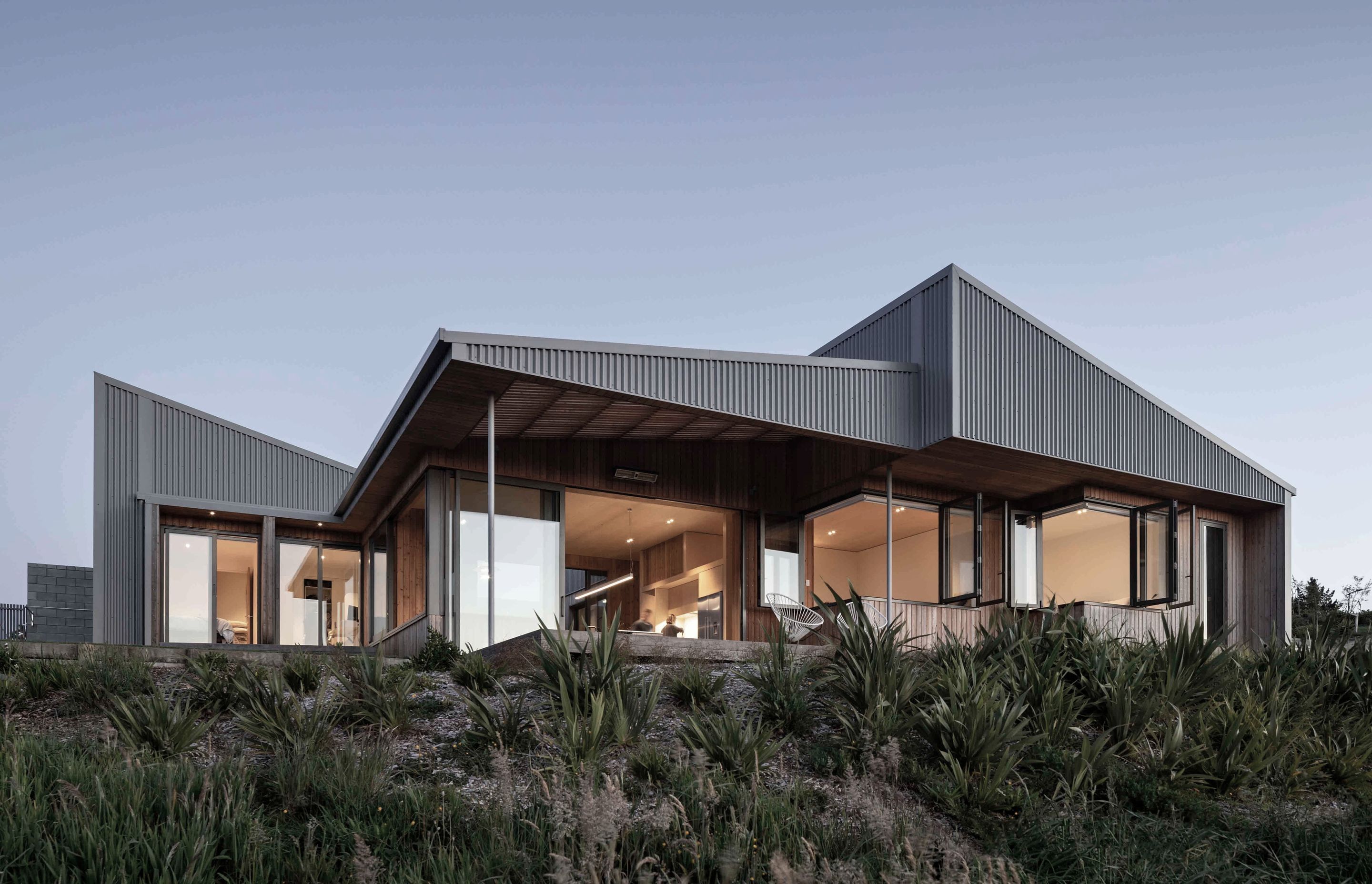 The exterior materiality features a corrugated cladding that ties into the rural typology of the home.