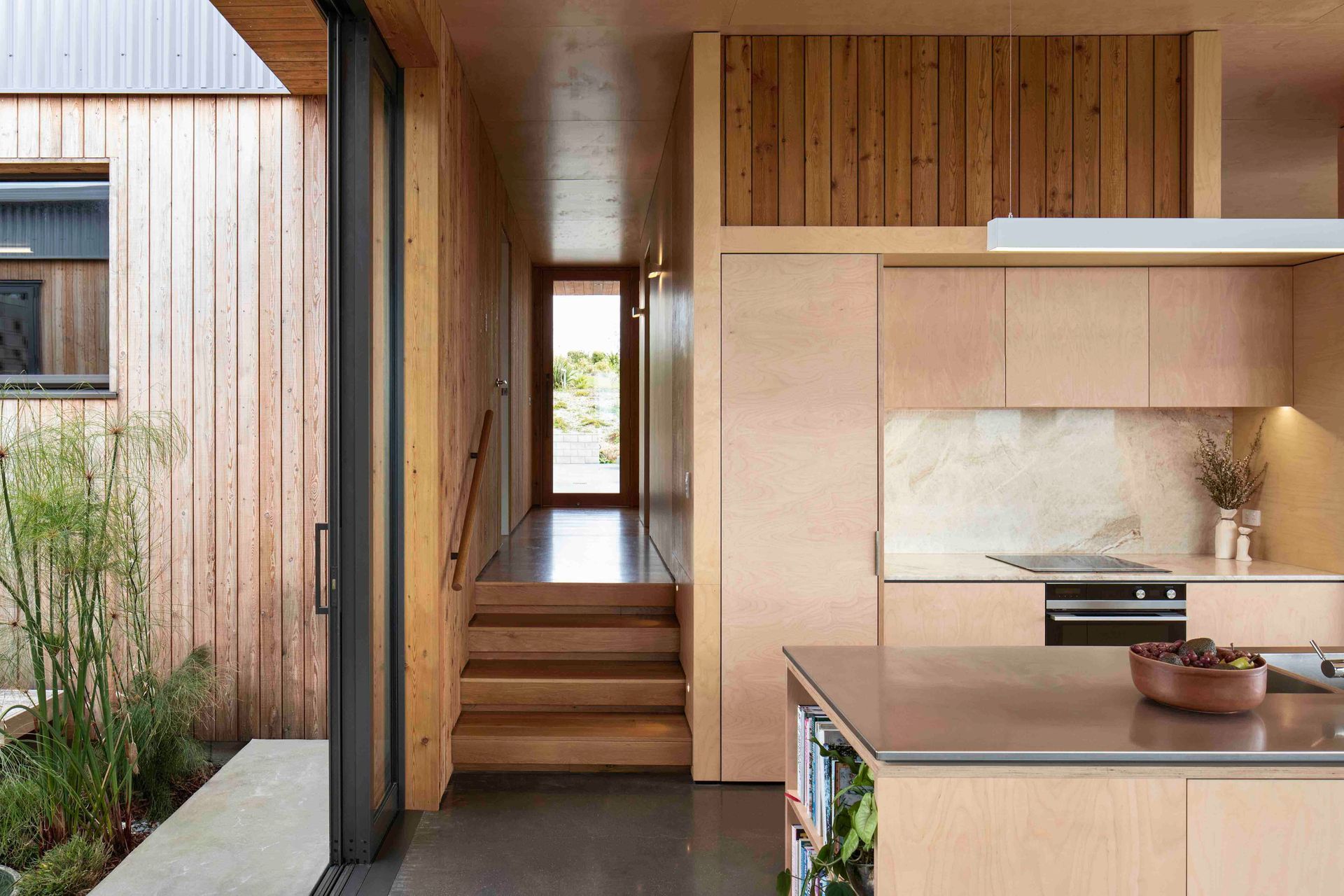 The living space flows out to the courtyard through large stacked sliders.