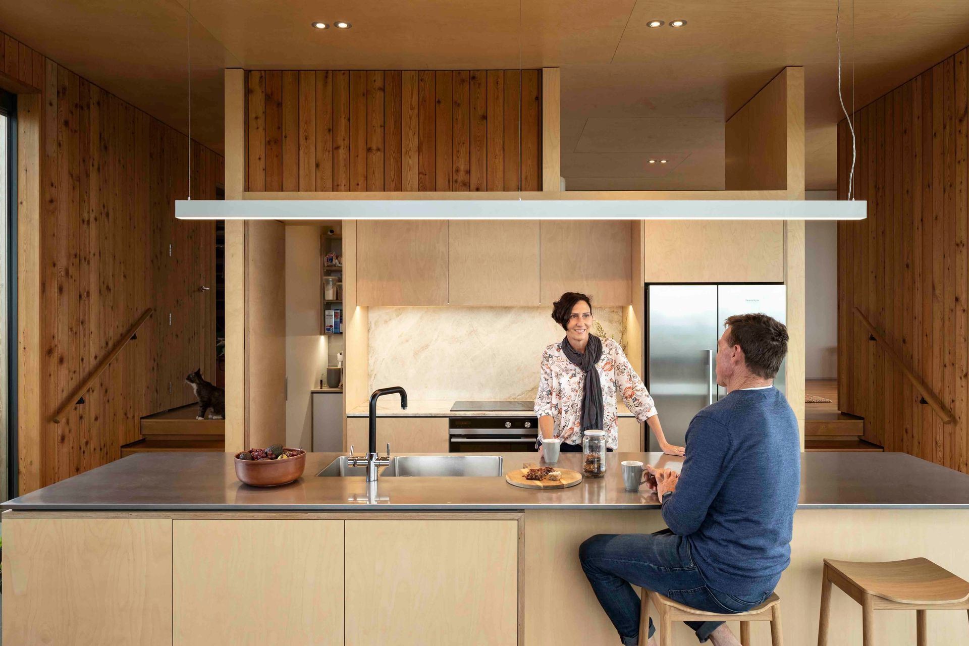 On either side of the kitchen, stairs access the different wings of the bedroom spaces.