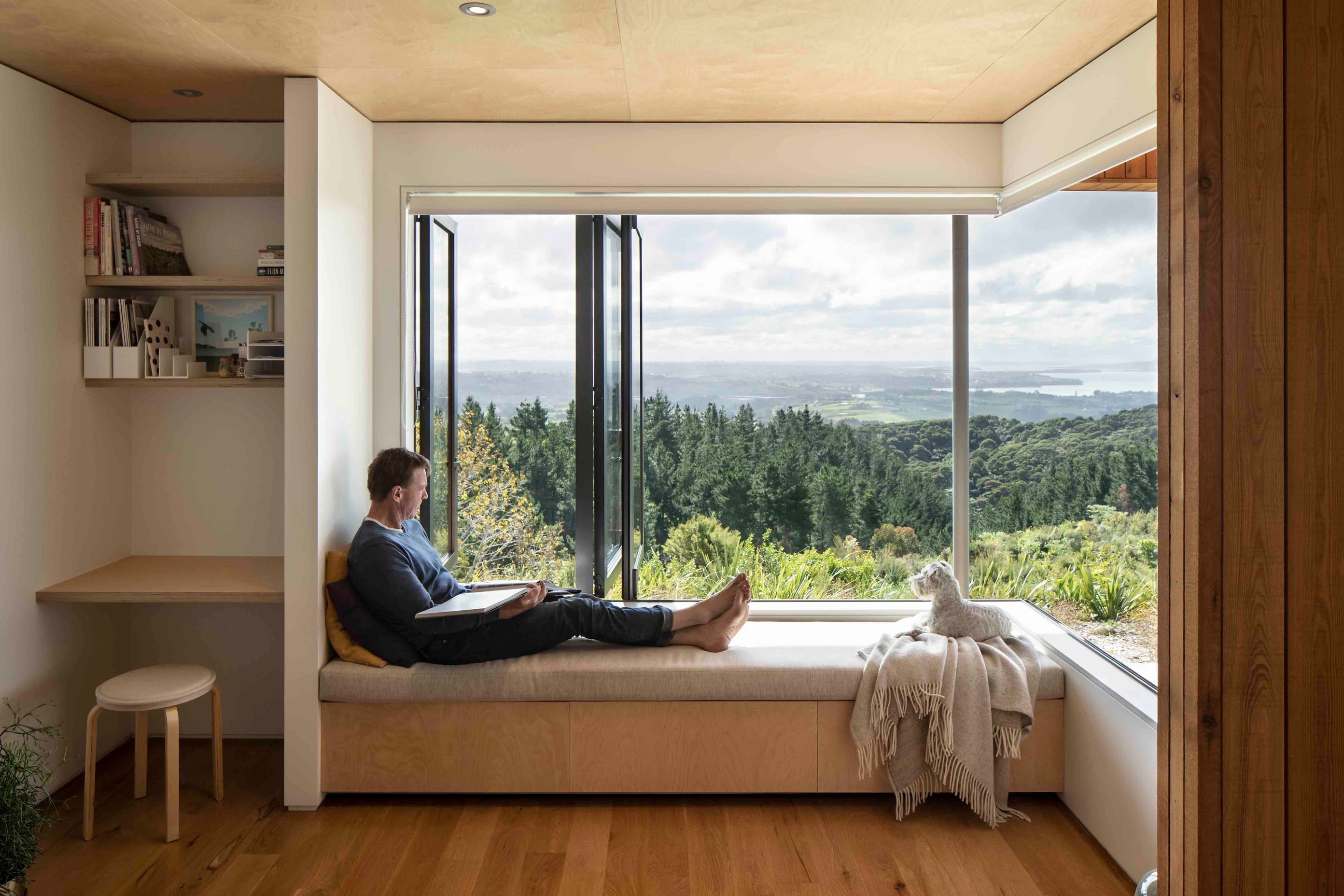 The living room features a window seat - the perfect spot to stop and enjoy the setting.