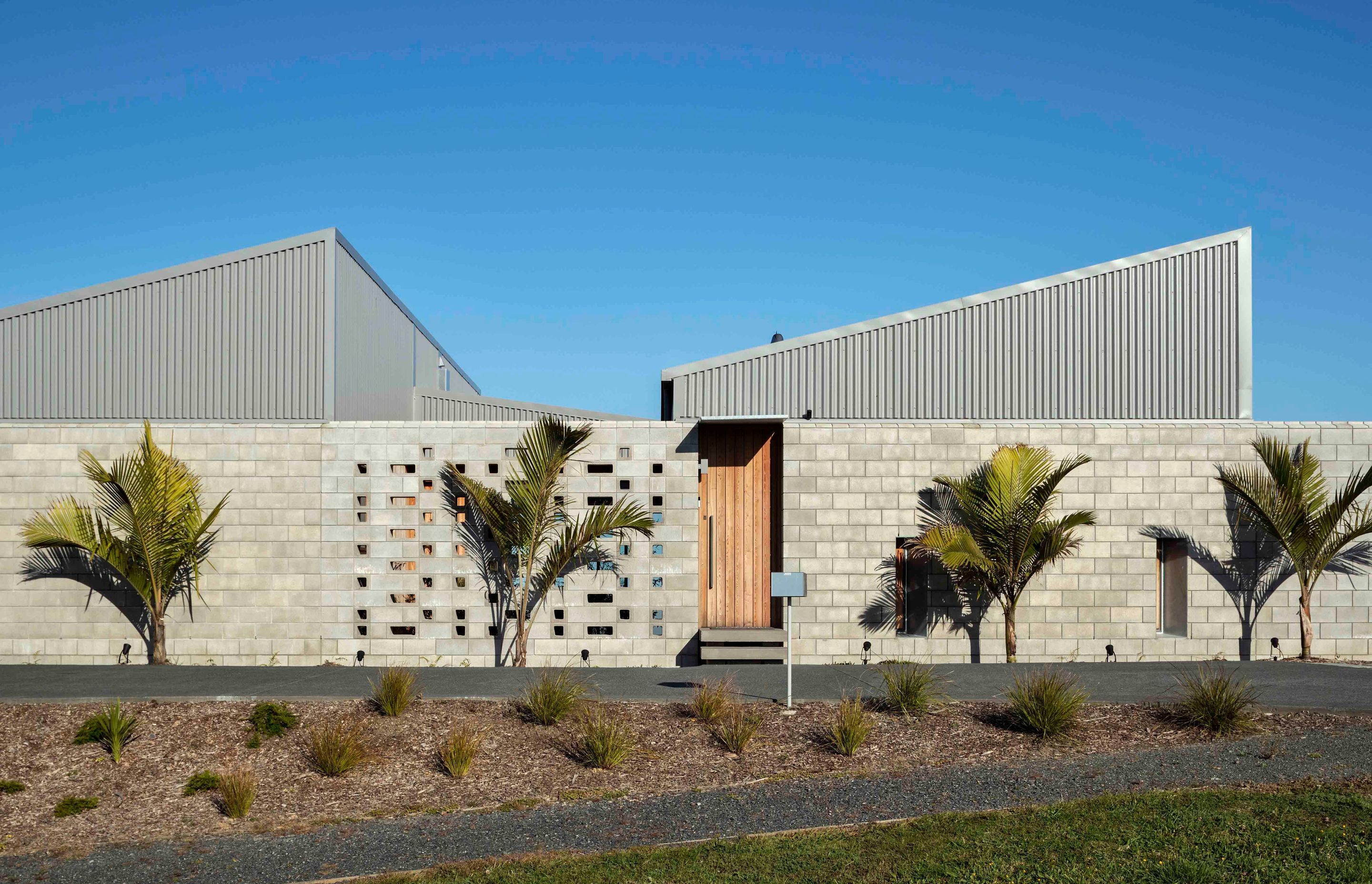 The two roof forms seen from the street make a bold geometric statement.