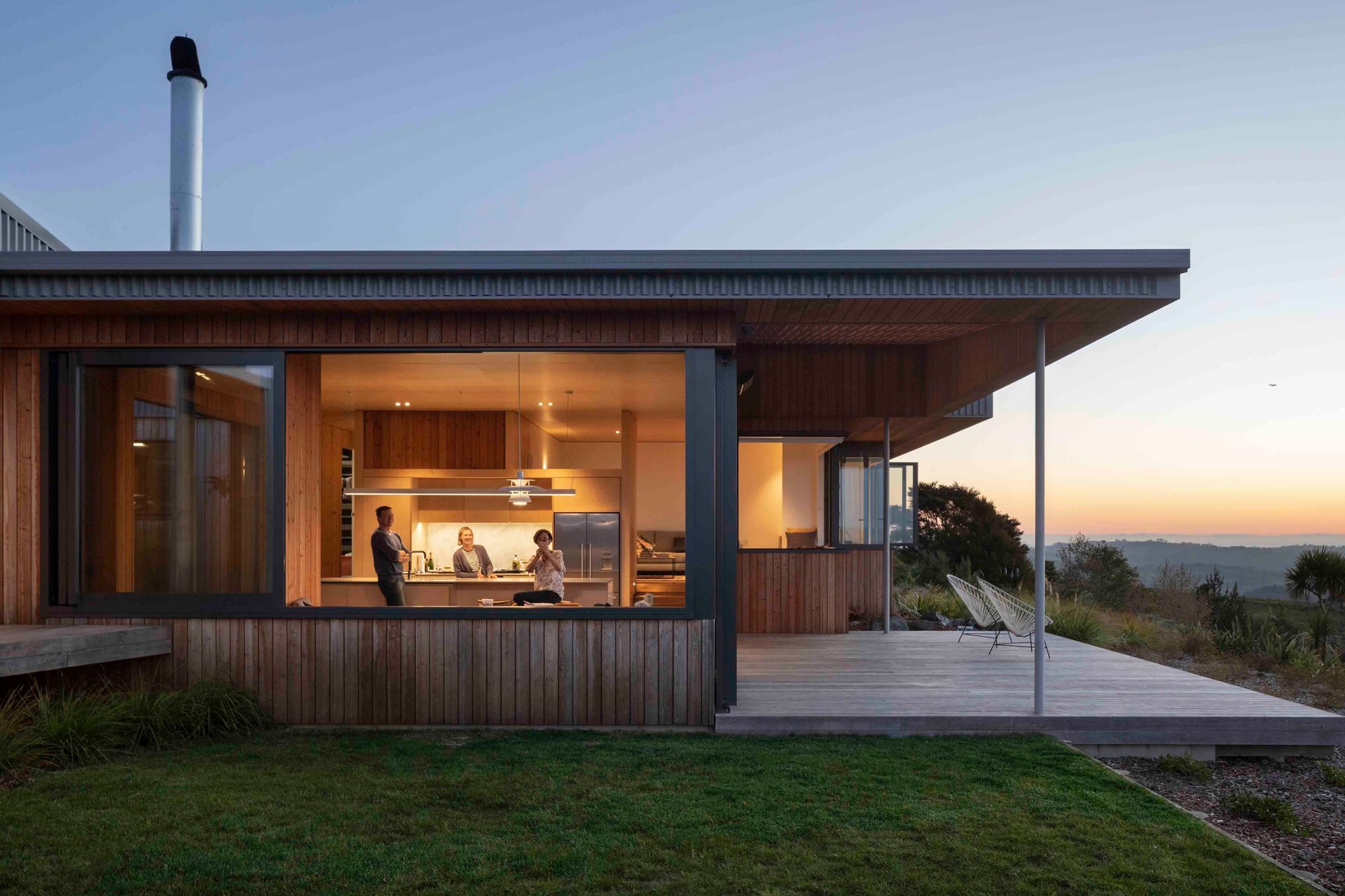 At night, the living space lights up and provides the perfect indoor/outdoor entertaining space for the homeowners.