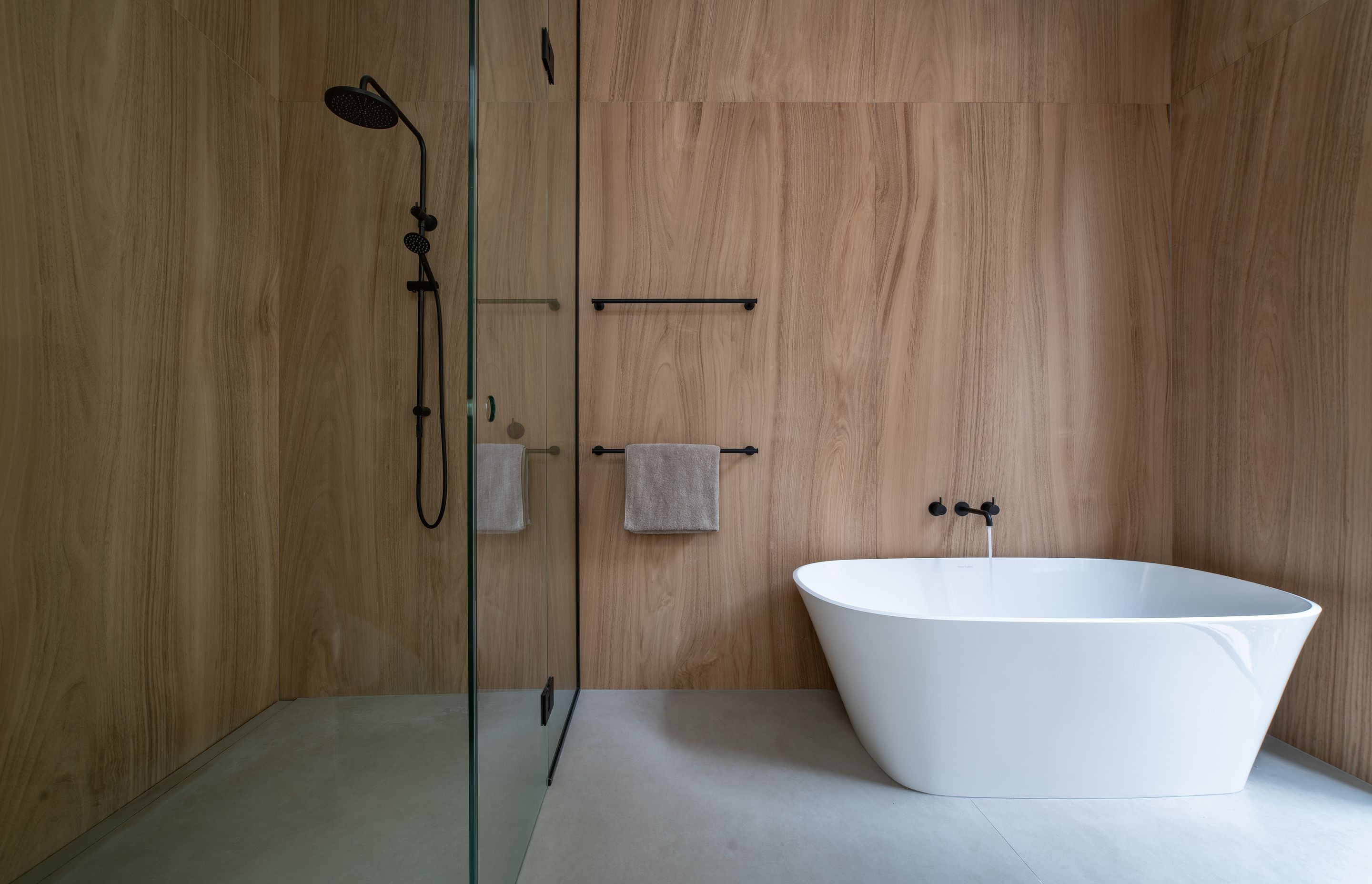 Oversized timber-look tiles create a peaceful, calming space in the ensuite bathroom, consistent with the palette in the rest of the home.