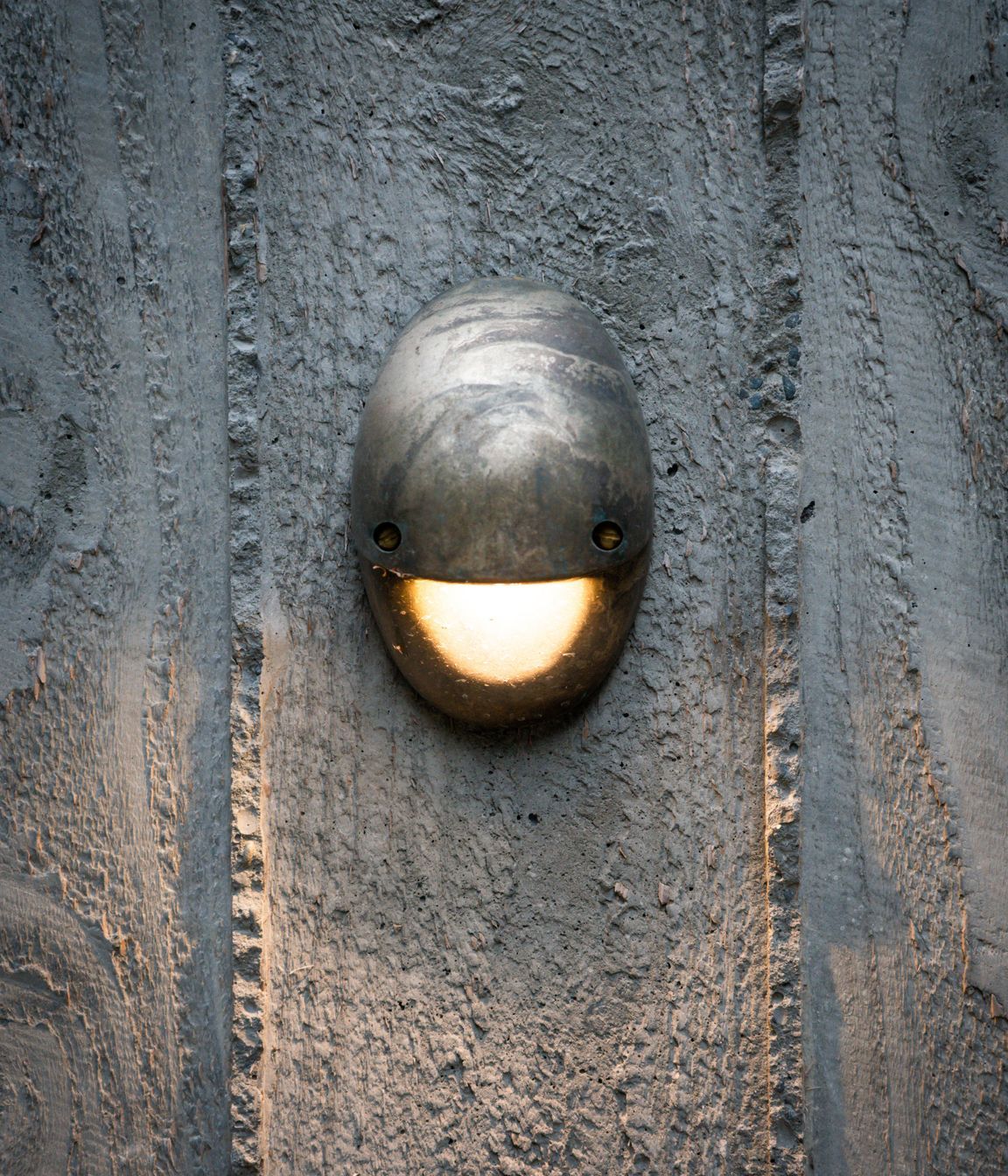 Lighting highlights the rough texture of the concrete.