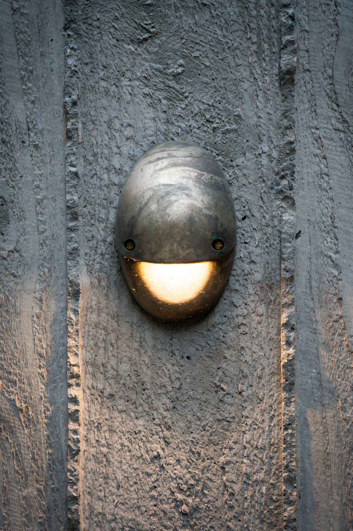 Lighting highlights the rough texture of the concrete.