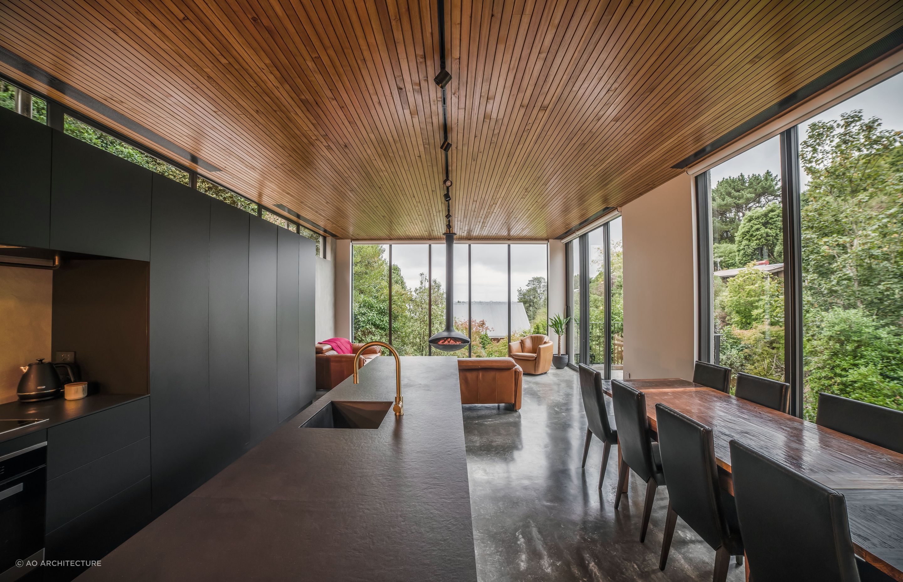 Matte cabinetry and a black benchtop with a unique velvet-like appearance maintain the pared back material palette.