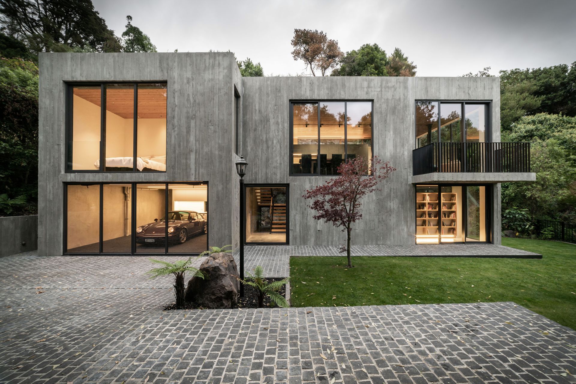 Cobbles and grass define the landscaping; simple and neutral while adding to the overall textural elements of the form.