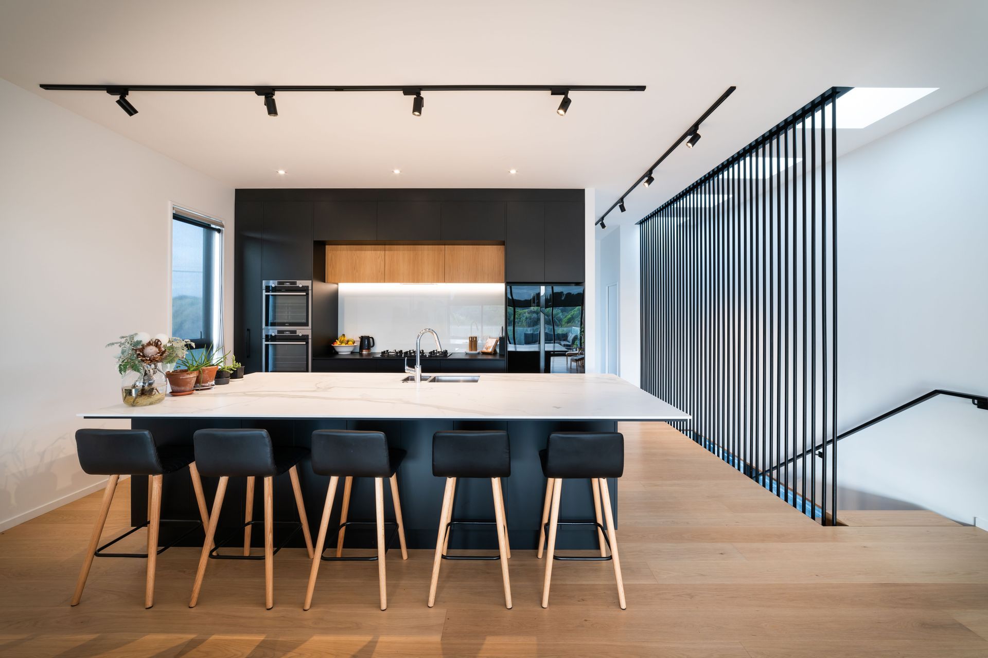 Upstairs, the palette pares back with an open-plan area of monochromatic hues coupled with a timber floor.