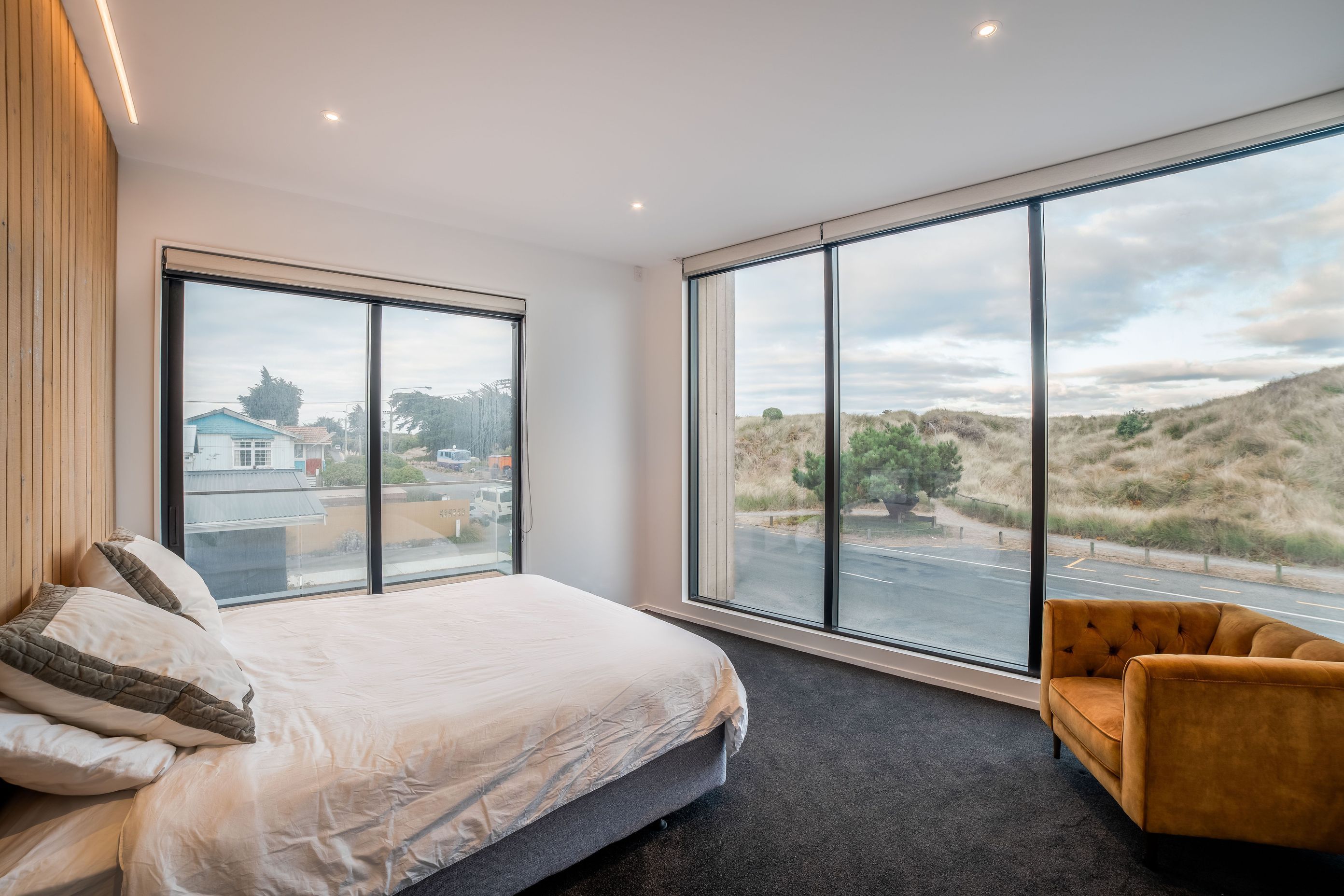 Full height glazing in the master bedroom affords views across to the dunes. 
