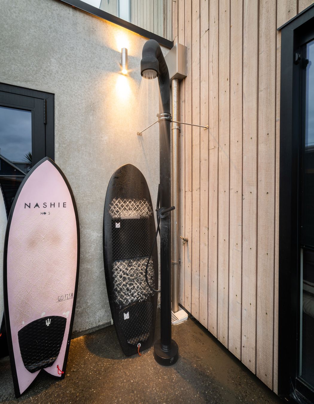 The hot outdoor shower is located in a private nook at the rear of the garage.