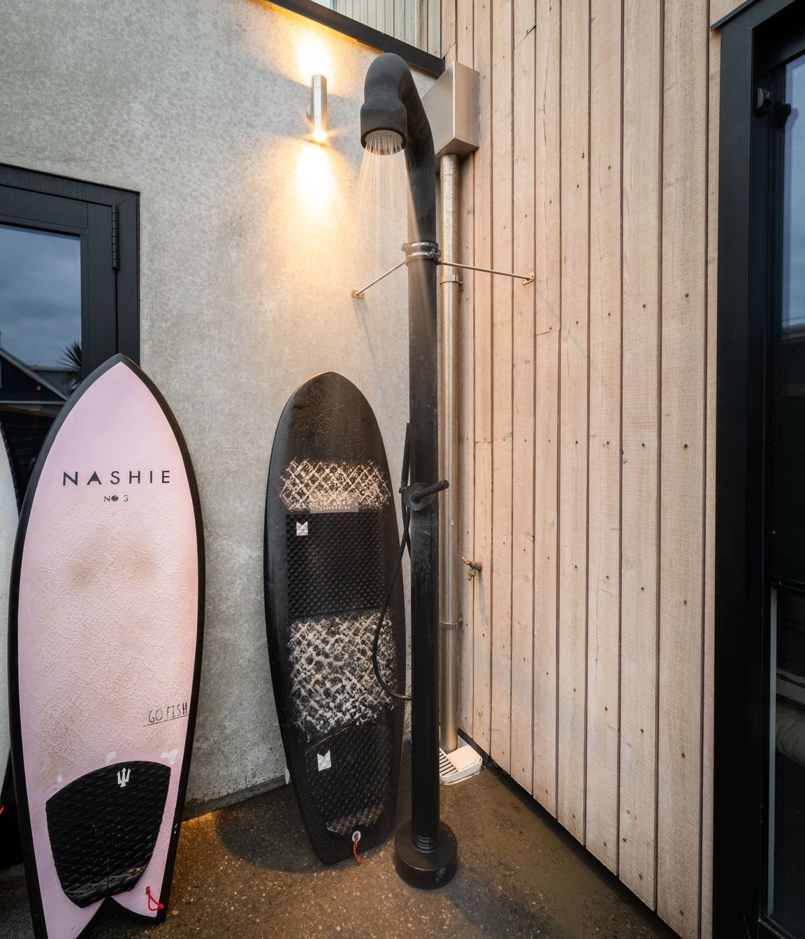 The hot outdoor shower is located in a private nook at the rear of the garage.