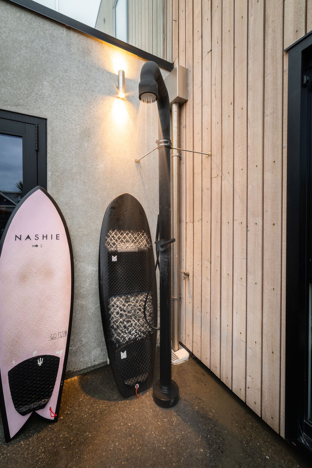 The hot outdoor shower is located in a private nook at the rear of the garage.