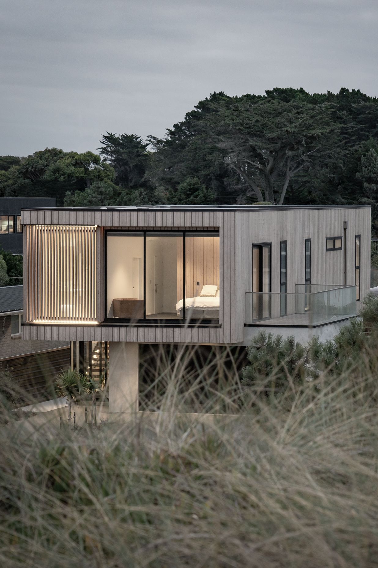 Occupying the entire cantilevered area, a spacious en suite shower room is shielded with larch fins.