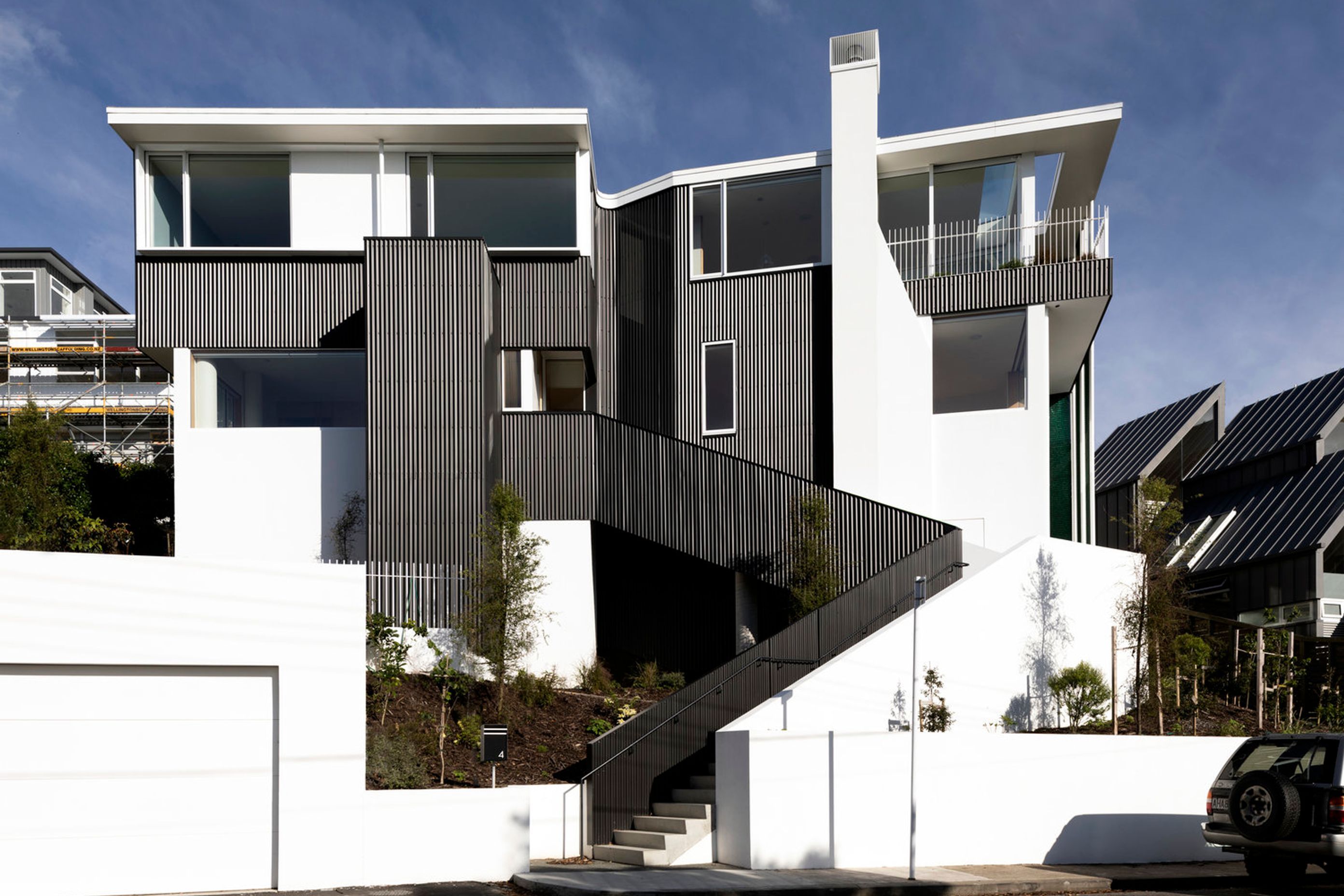 A dramatic frontage makes a show of the pre-weathered zinc corrugated cladding. A flat roof has a two-layer torch-on membrane over panels to form a warm roof.