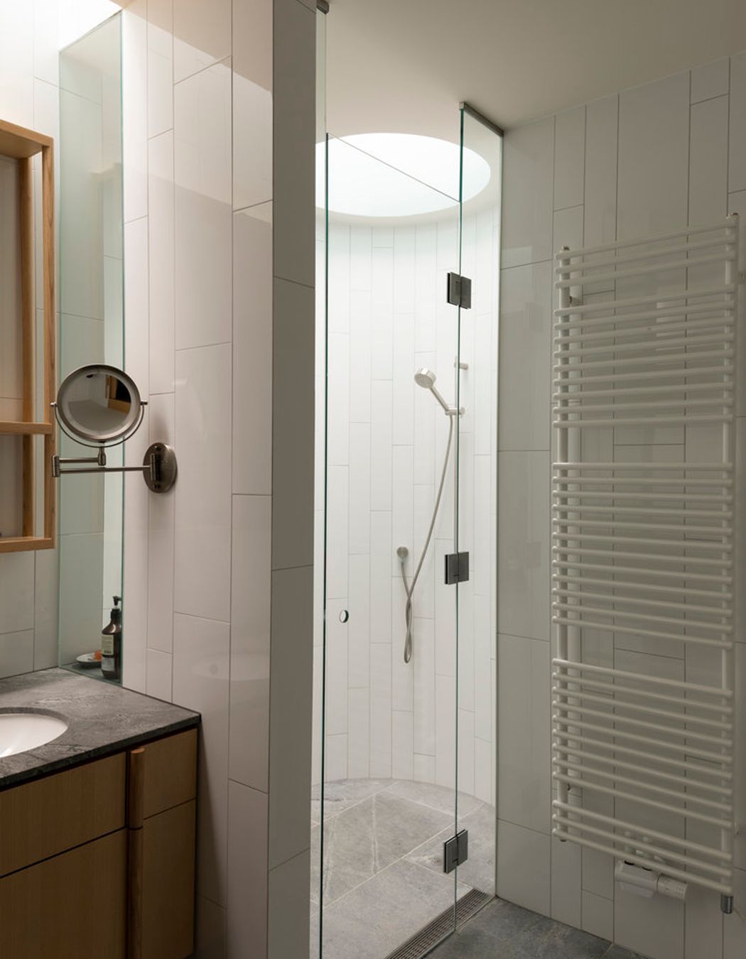 A simple materials palette includes timber and granite in the bathrooms.