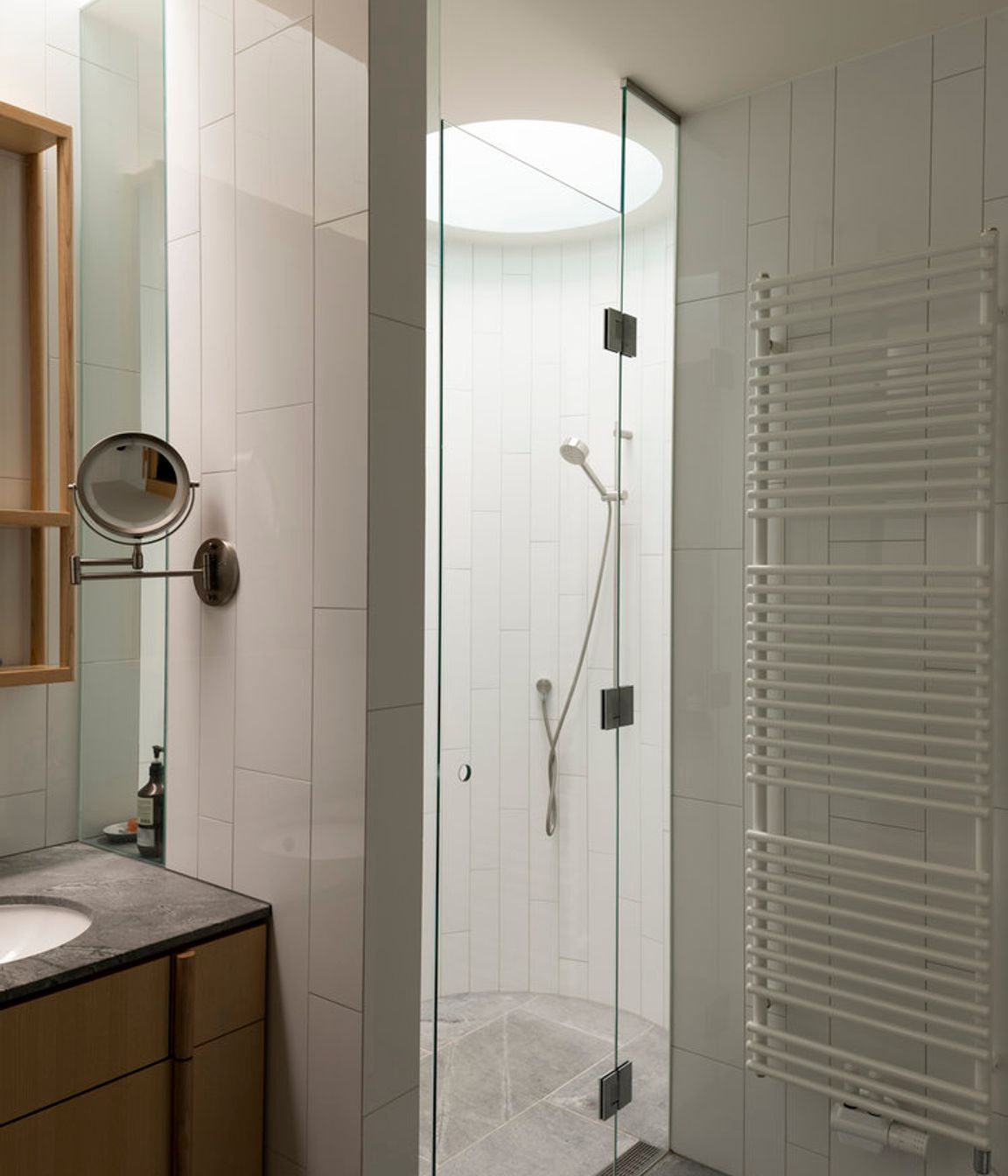 A simple materials palette includes timber and granite in the bathrooms.