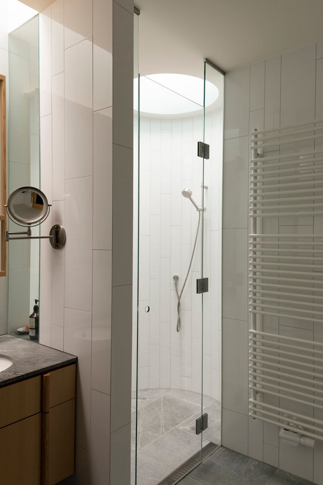 A simple materials palette includes timber and granite in the bathrooms.