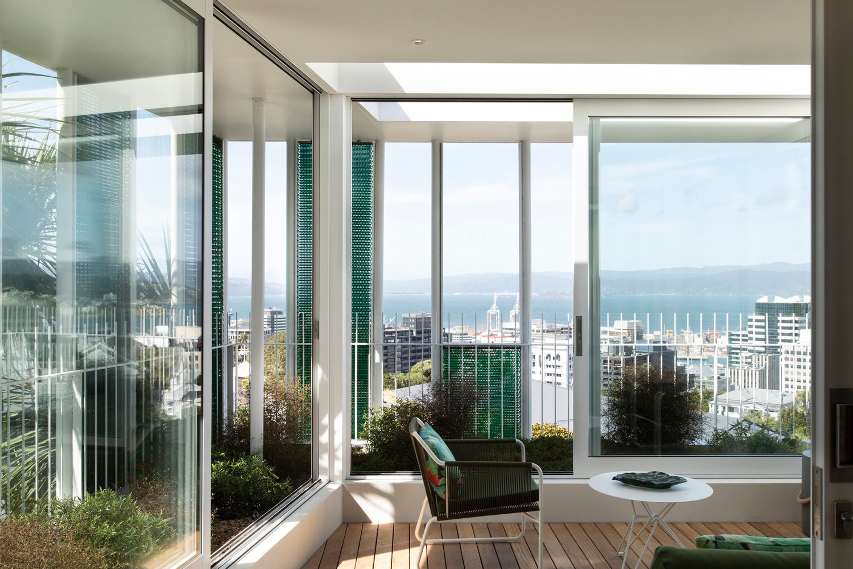 The winter garden in the upstairs apartment features sliding doors that open the interior up to the spectacular view of Wellington harbour and city.
