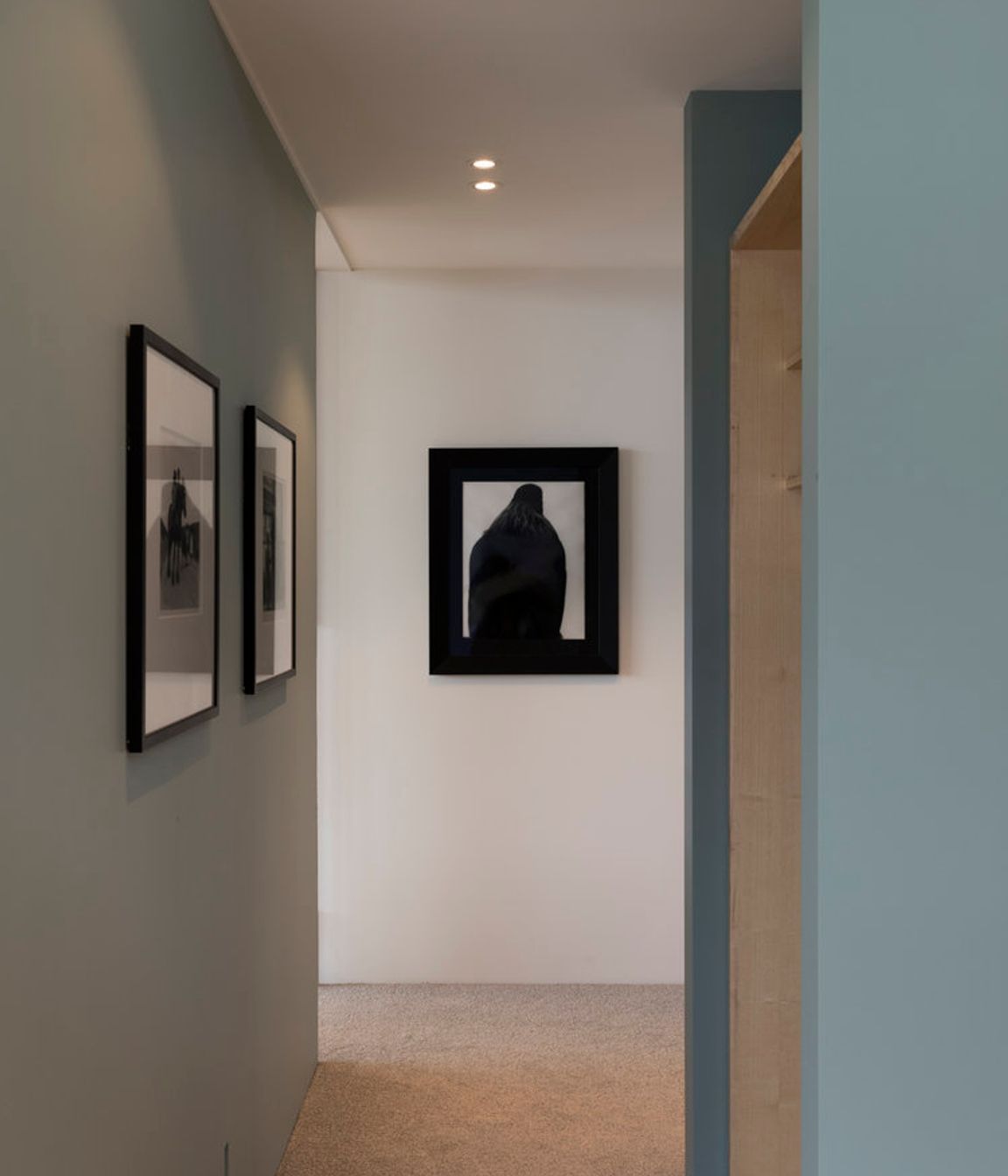 The hallway shows Parsonson's signature colour palette of soft, muted greens and blues.