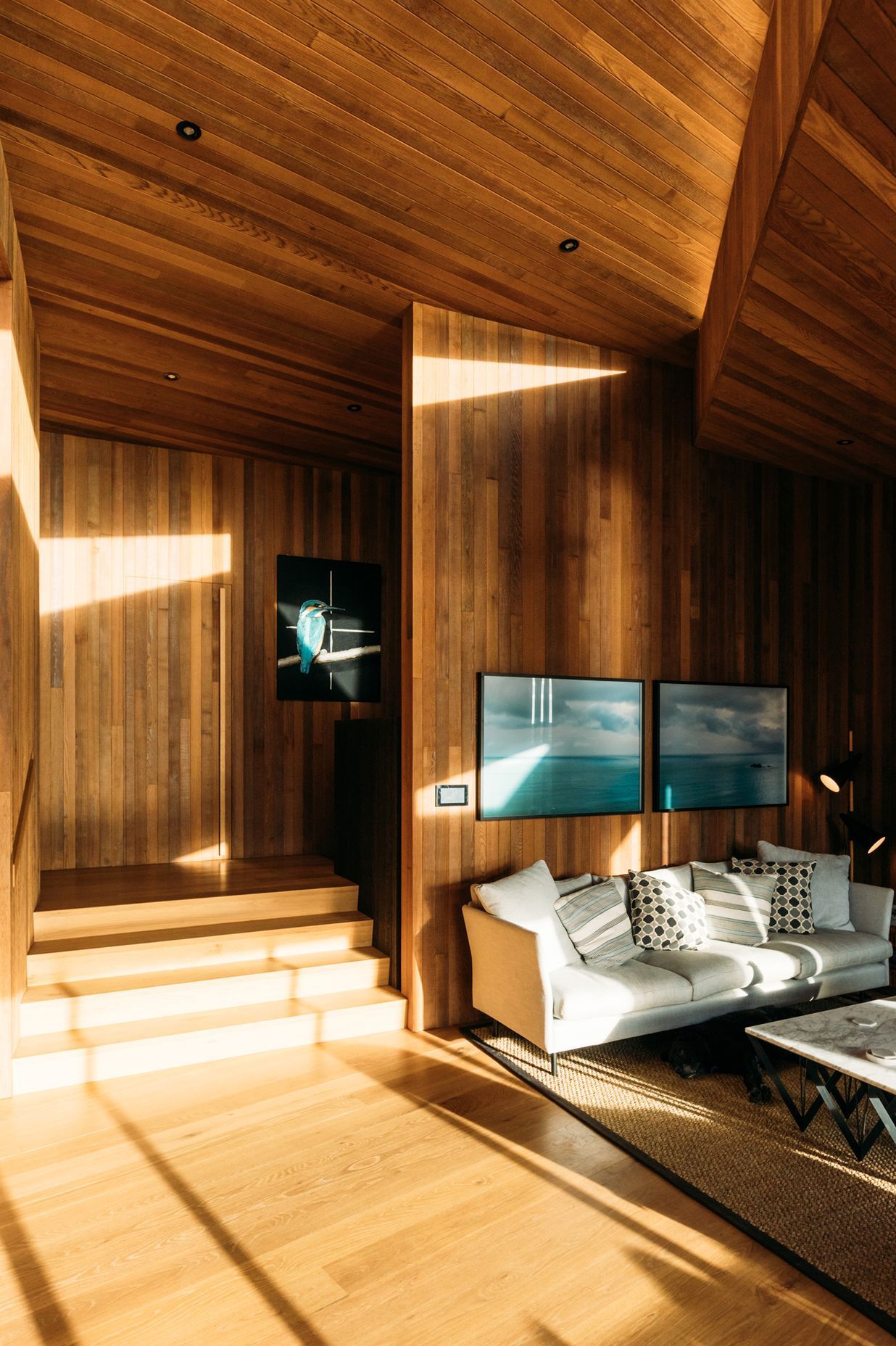 A large, triangular skylight above the living area, helps draw light into the interior throughout the day.