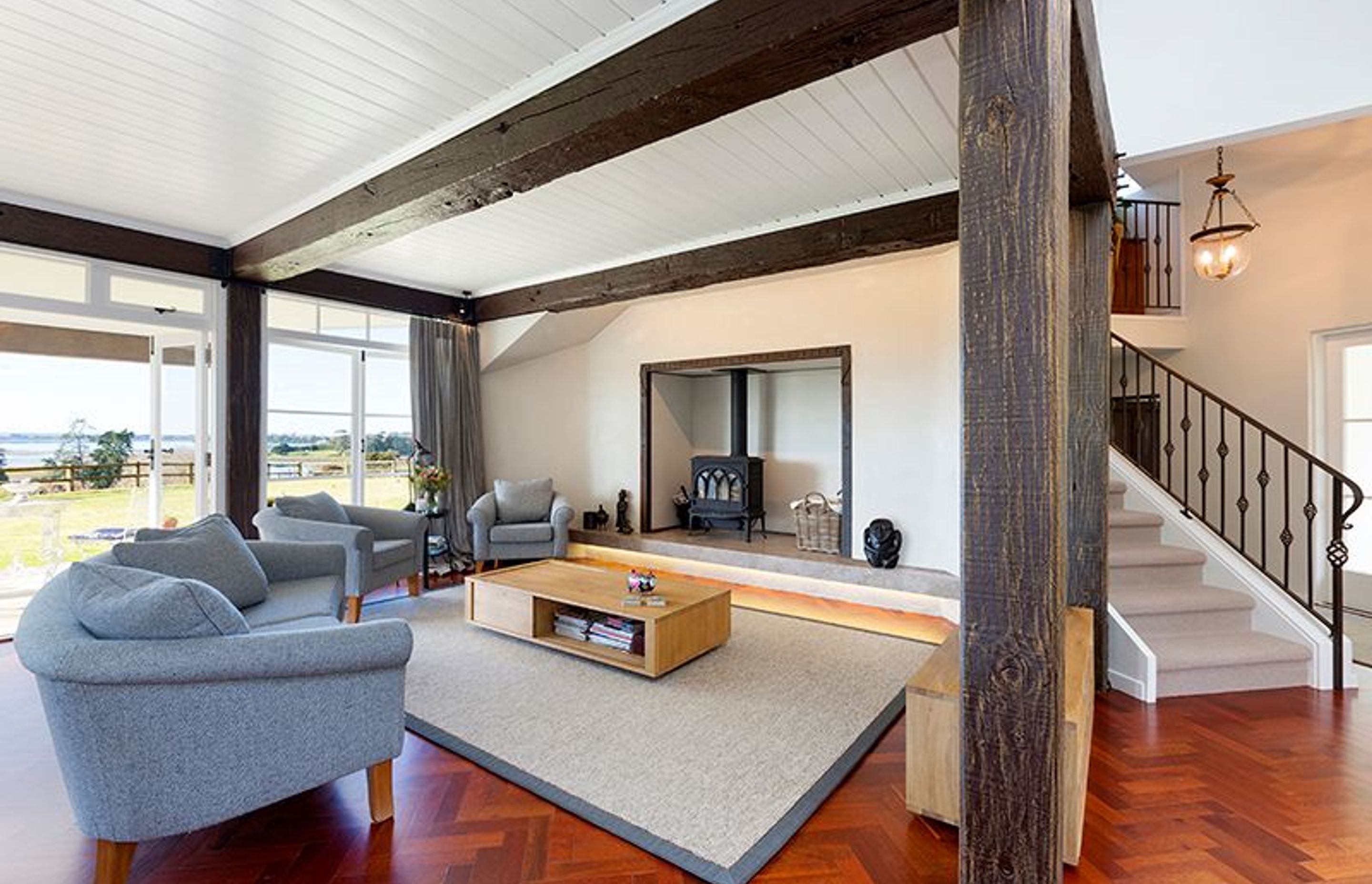 Family room, Artisan Flooring leather bound custom rug, bespoke wrought iron balustrade to stairwell