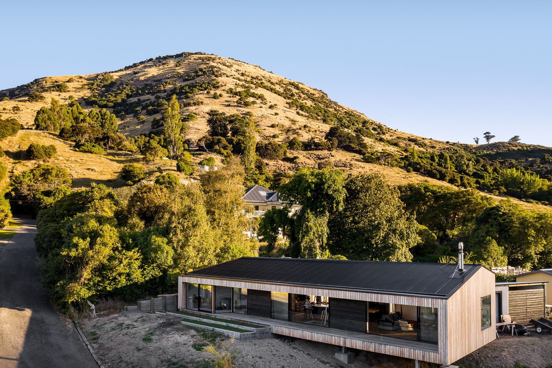 Siberian larch cladding silvers off over time and compliments the colours of the grasses on the Port Hills, while a corrugated Colorsteel Maxx roof minimises maintenance requirements.