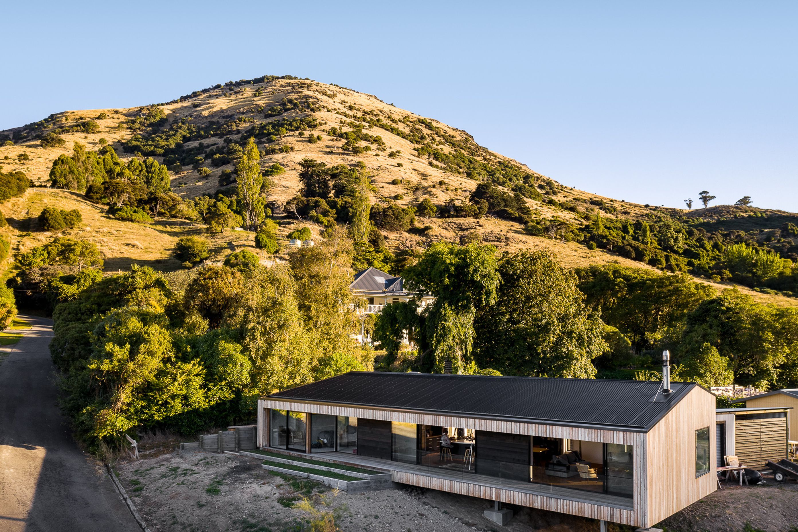 Siberian larch cladding silvers off over time and compliments the colours of the grasses on the Port Hills, while a corrugated Colorsteel Maxx roof minimises maintenance requirements.