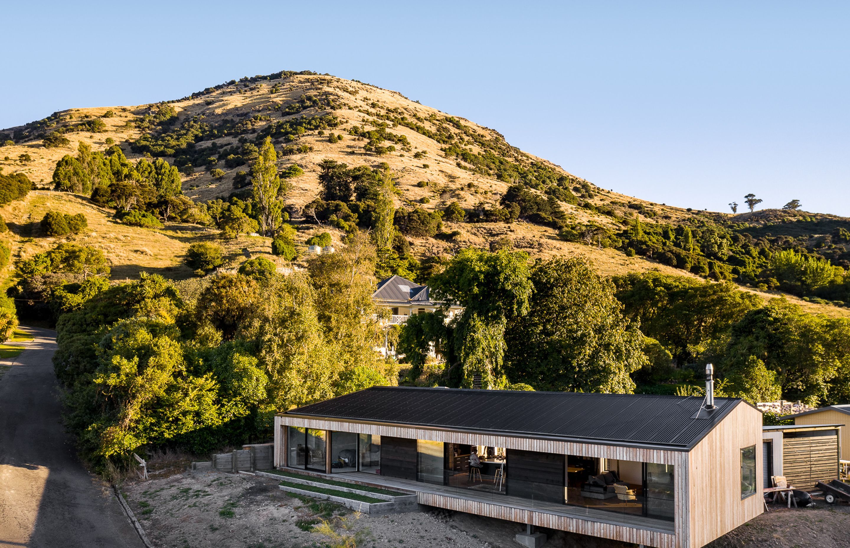 Siberian larch cladding silvers off over time and compliments the colours of the grasses on the Port Hills, while a corrugated Colorsteel Maxx roof minimises maintenance requirements.