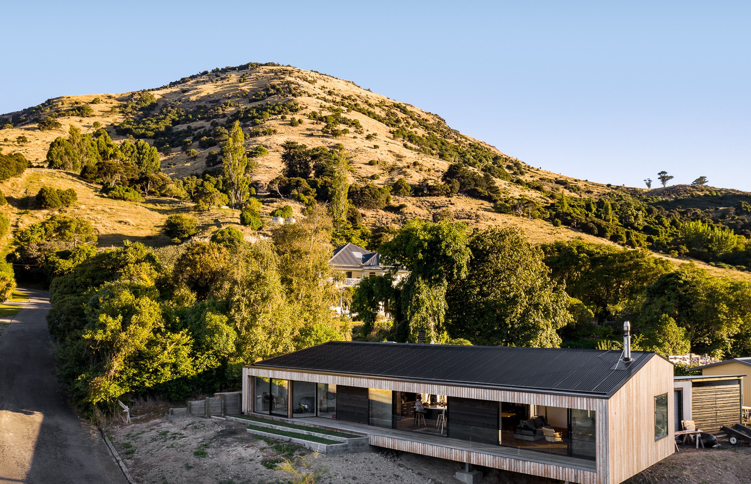 Siberian larch cladding silvers off over time and compliments the colours of the grasses on the Port Hills, while a corrugated Colorsteel Maxx roof minimises maintenance requirements.