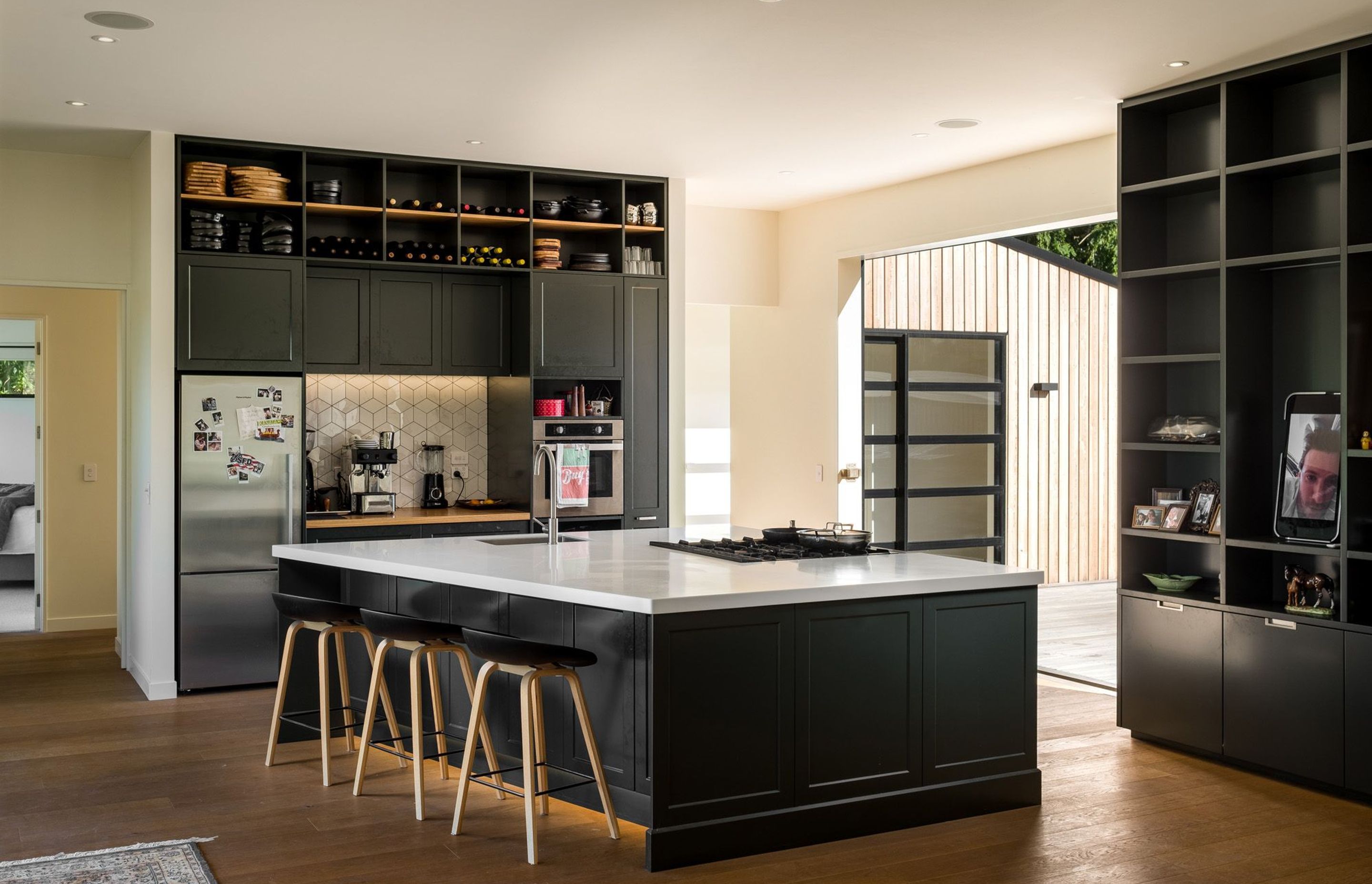 Designed by the chef owner and his family, the monochrome kitchen is a highly-functional space with a view of the sea from the cooker.