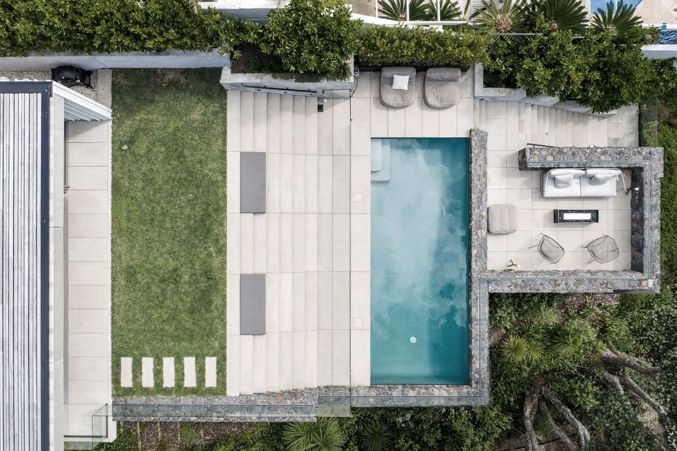 The site plan shows how basalt stone walls form terraces all the way up the steep site, which "creates solidity and nestles the house into the coast and into the water’s edge,” says Andrew Patterson.