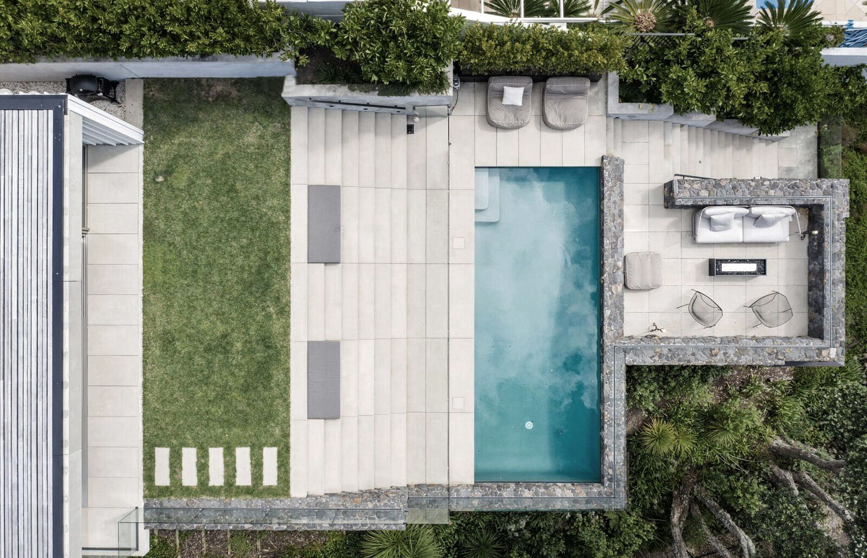 The site plan shows how basalt stone walls form terraces all the way up the steep site, which "creates solidity and nestles the house into the coast and into the water’s edge,” says Andrew Patterson.