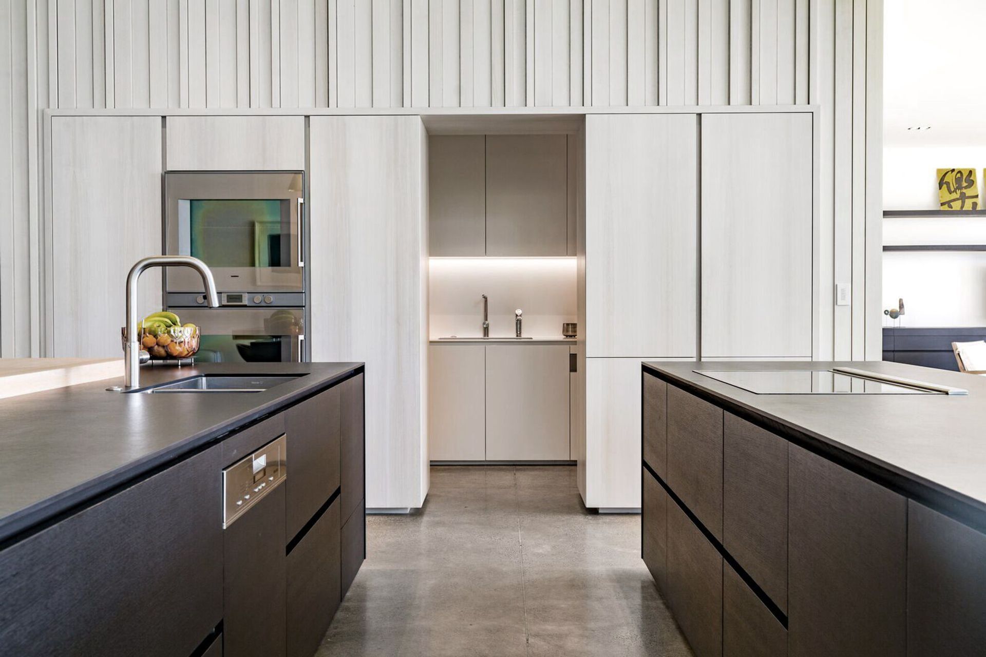 The central spine of the house encloses the scullery underneath the staircase.