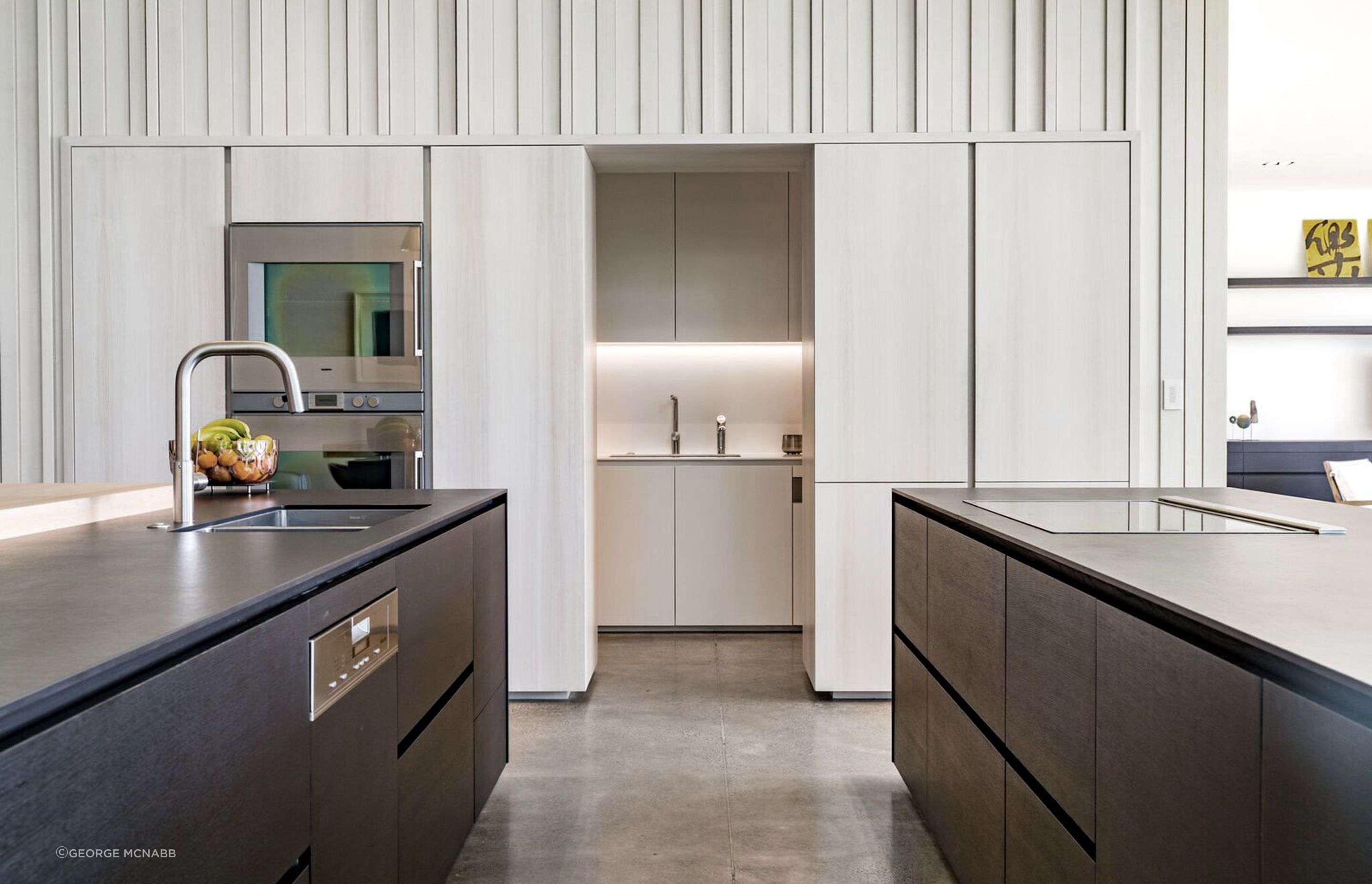 The central spine of the house encloses the scullery underneath the staircase.