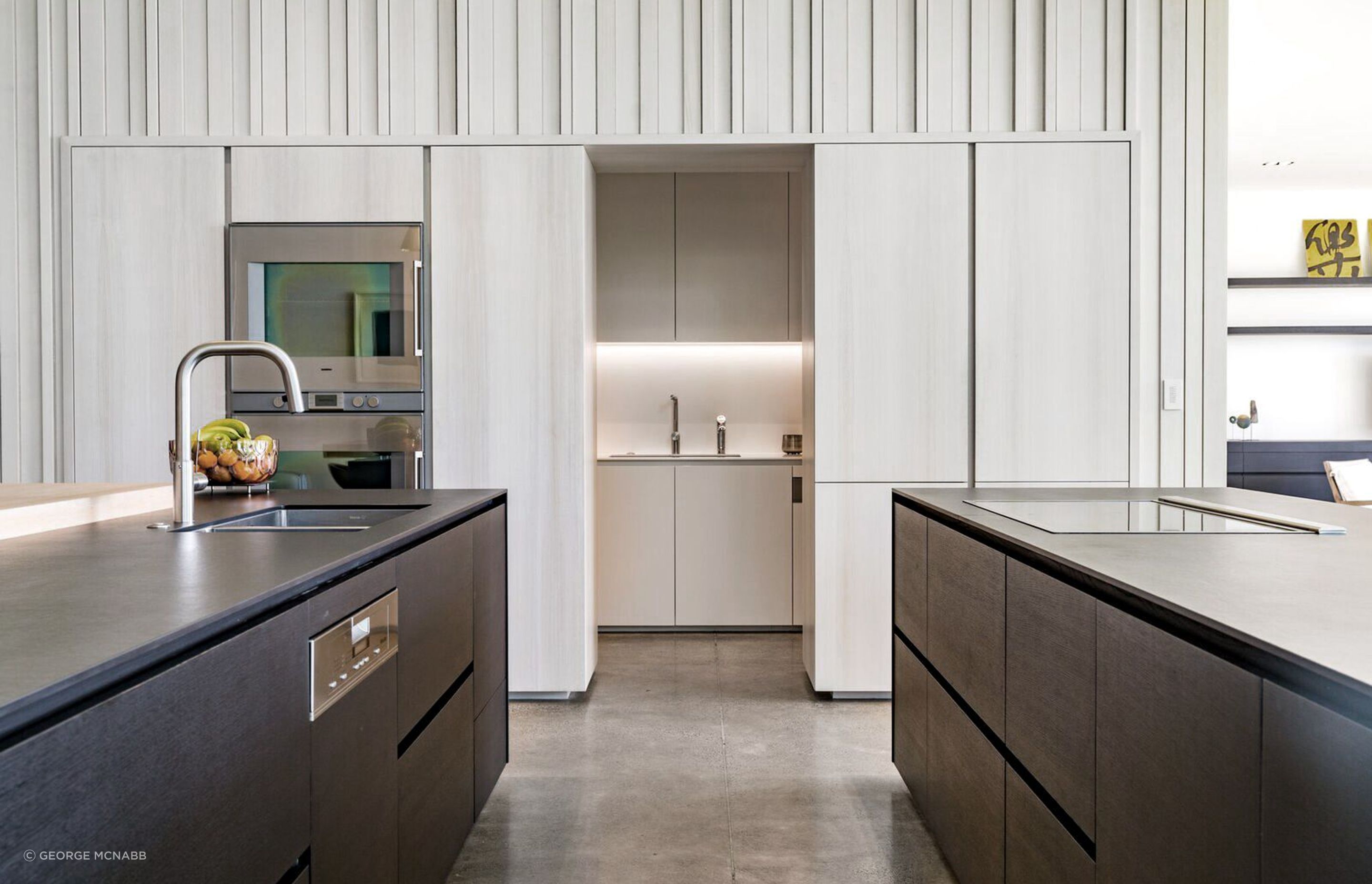 The central spine of the house encloses the scullery underneath the staircase.
