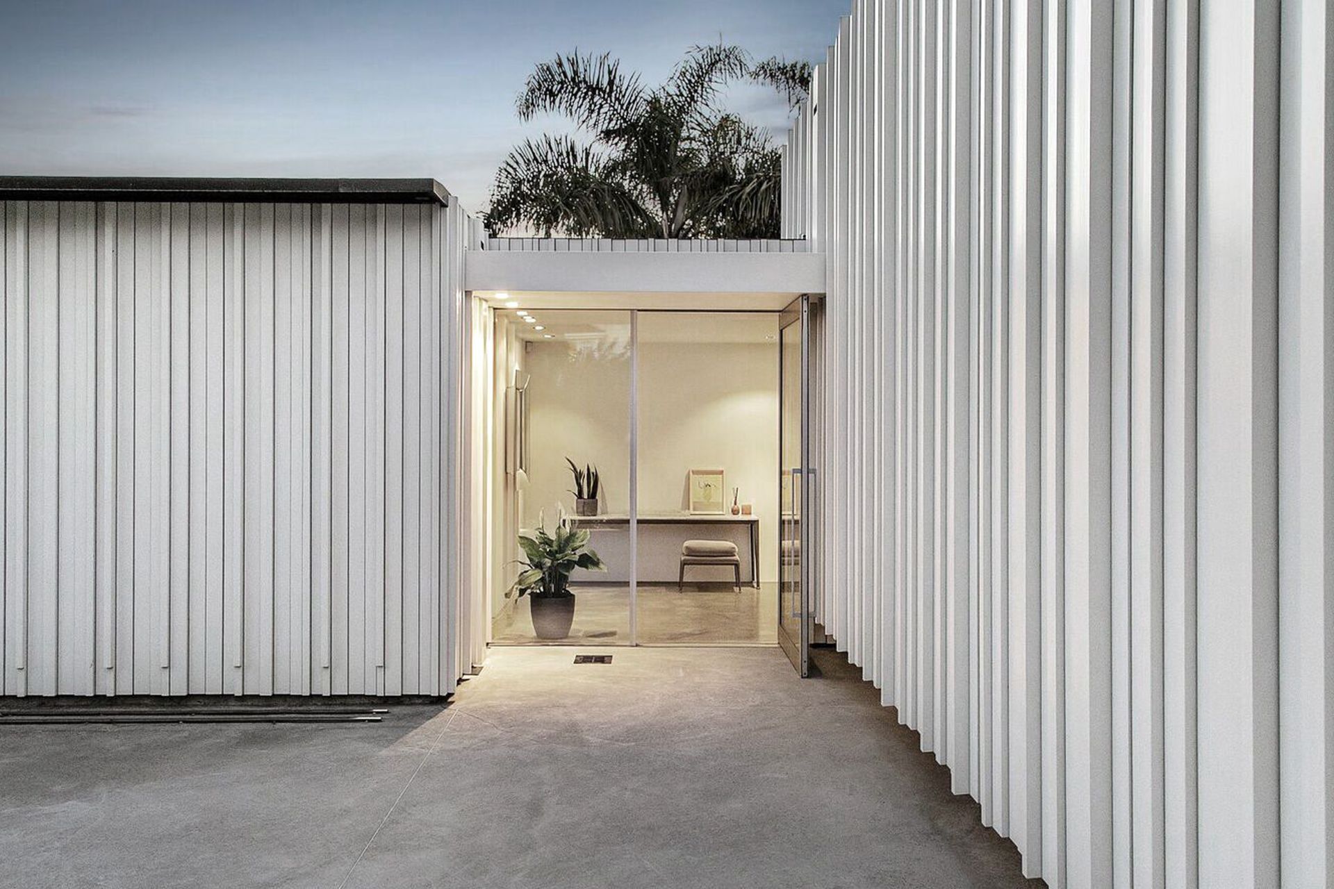 The glazed main entrance is framed by painted timber cladding which is carried through into the interior.