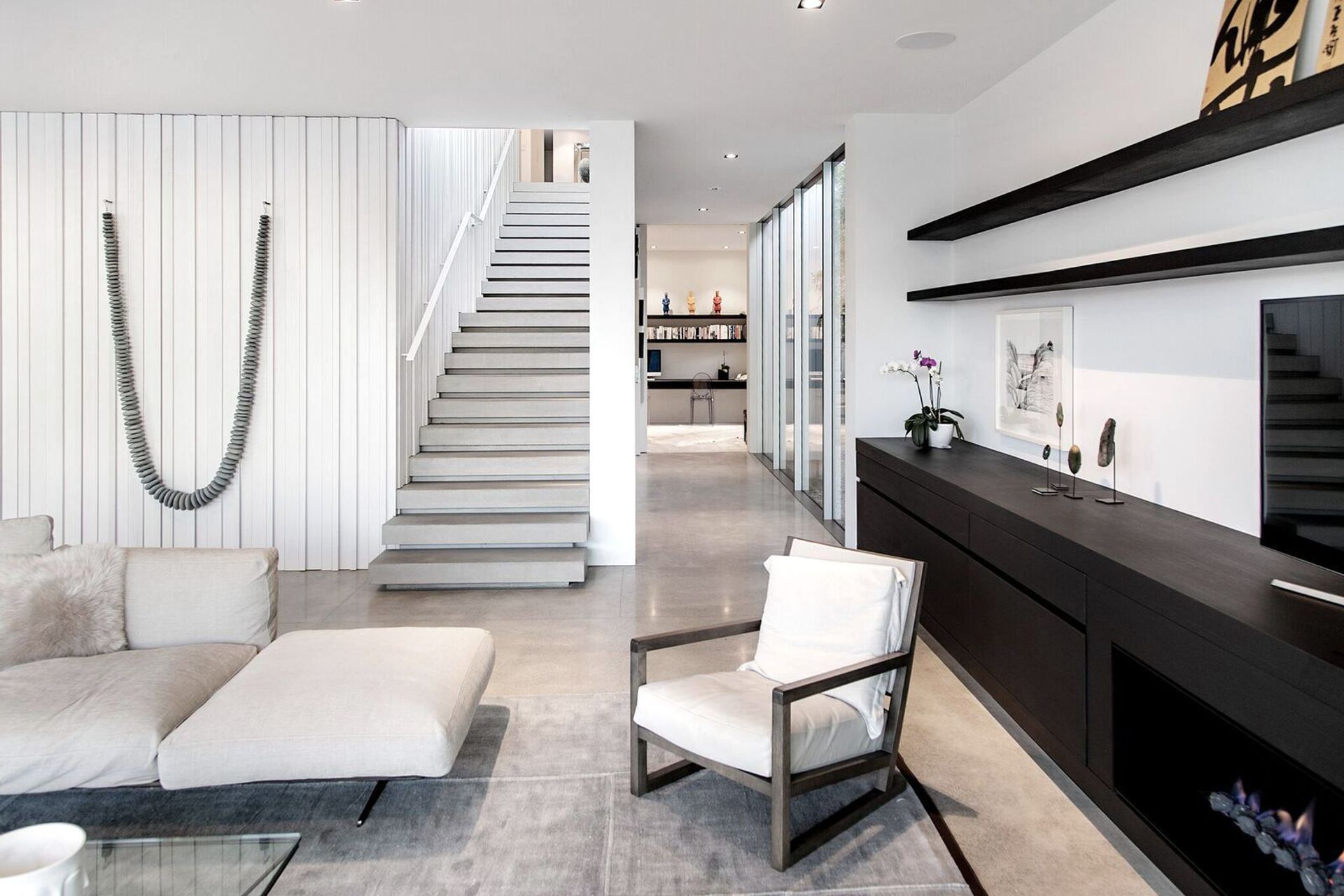 Artworks are key components of the interior design scheme, which makes the most of natural materials like timber, stone and concrete.