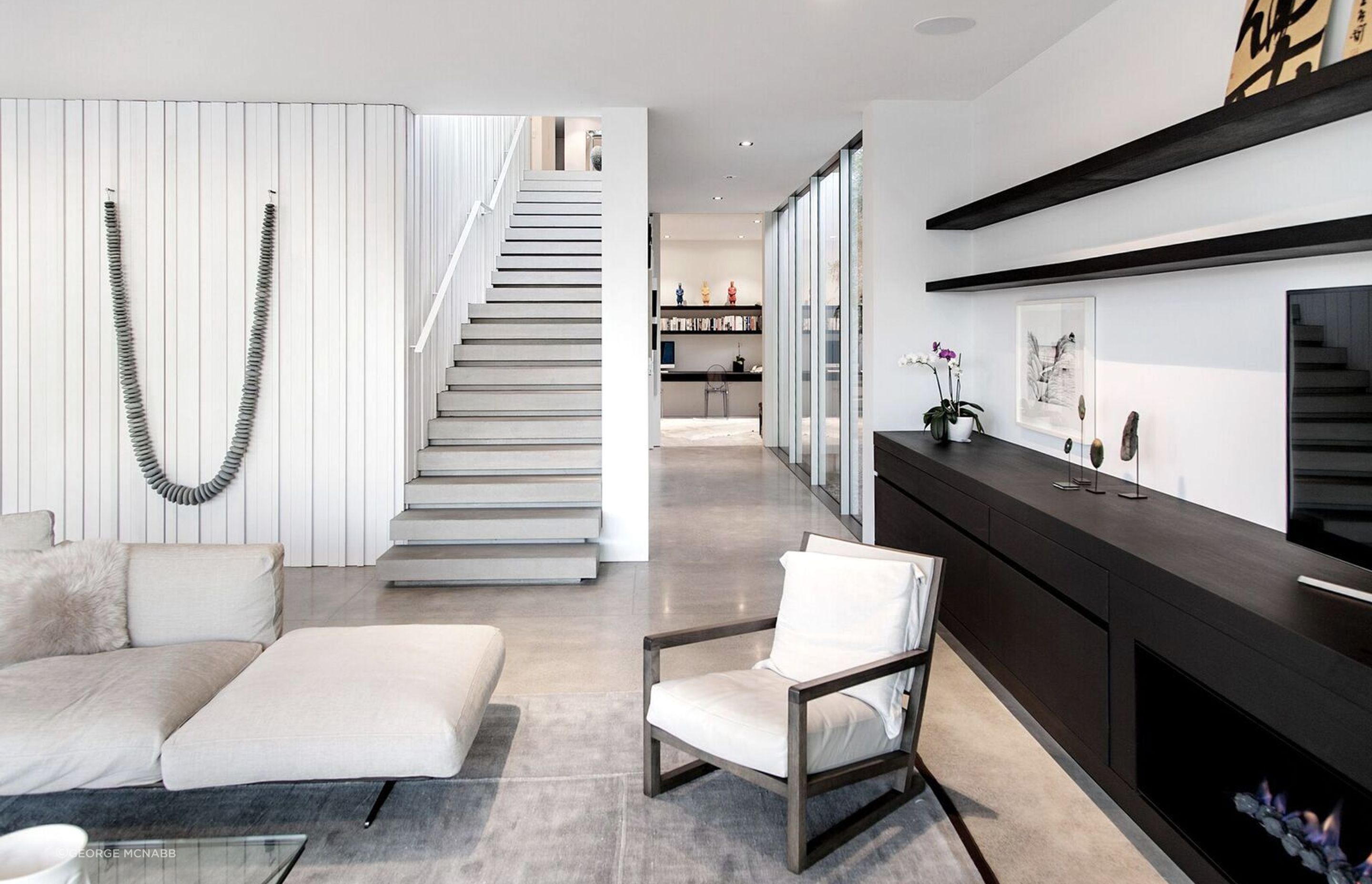Artworks are key components of the interior design scheme, which makes the most of natural materials like timber, stone and concrete.