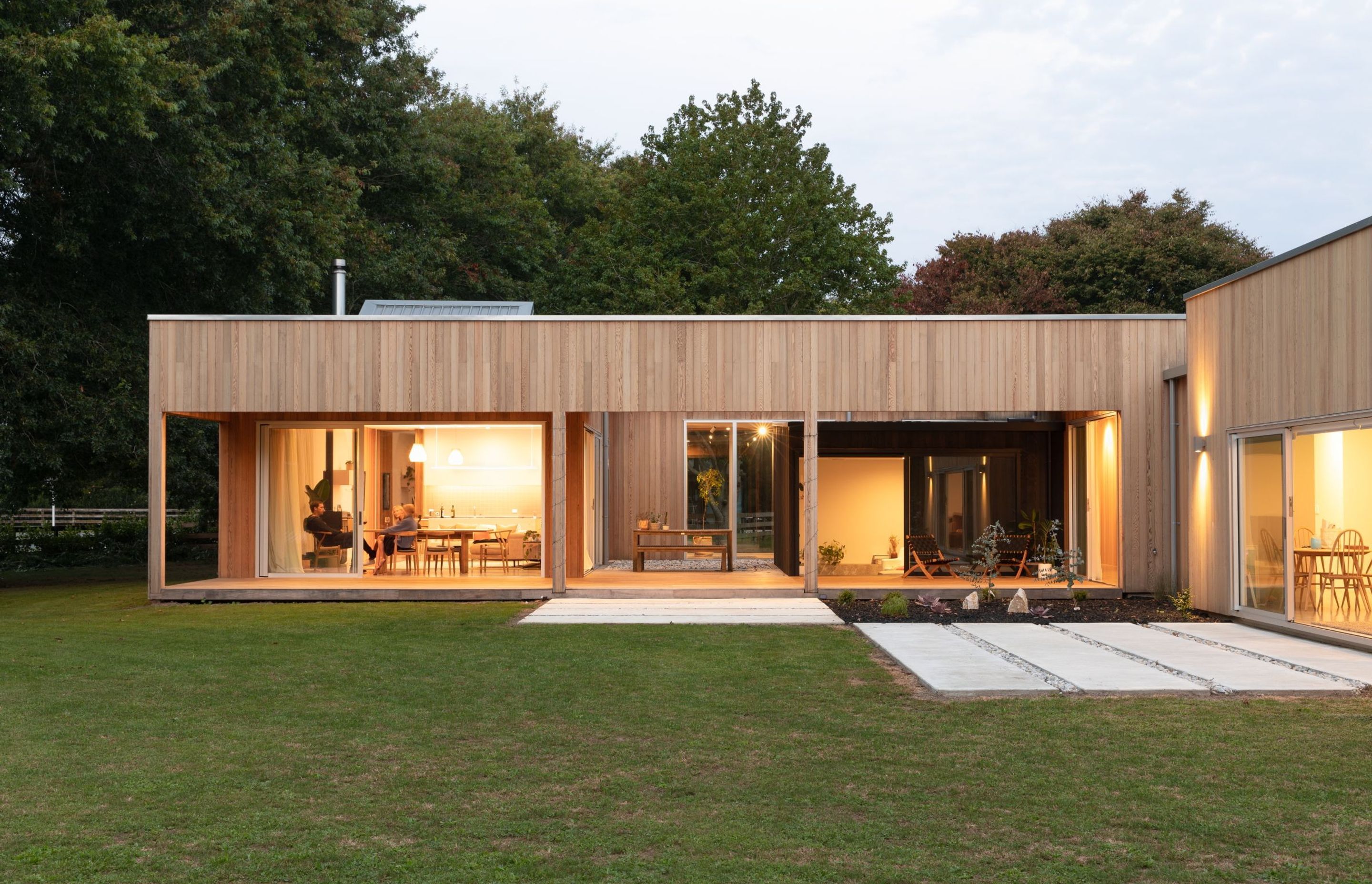 The main pavilion contains the living and dining areas, and an internal courtyard. The spatial arrangement creates a sense of a journey through the home.