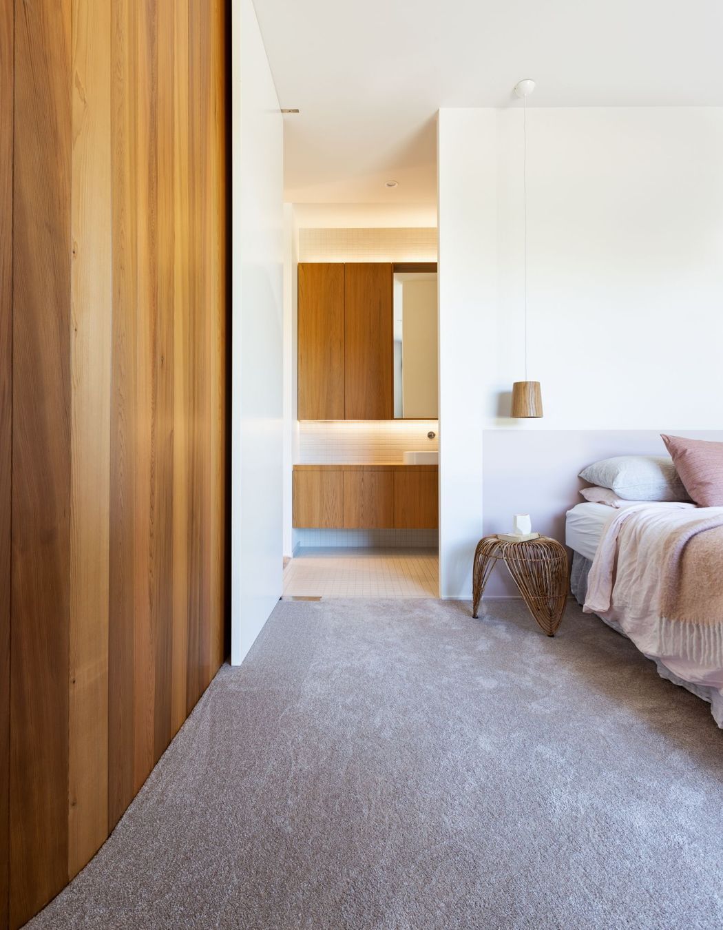 Understated colours and materials continue into the master bedroom.