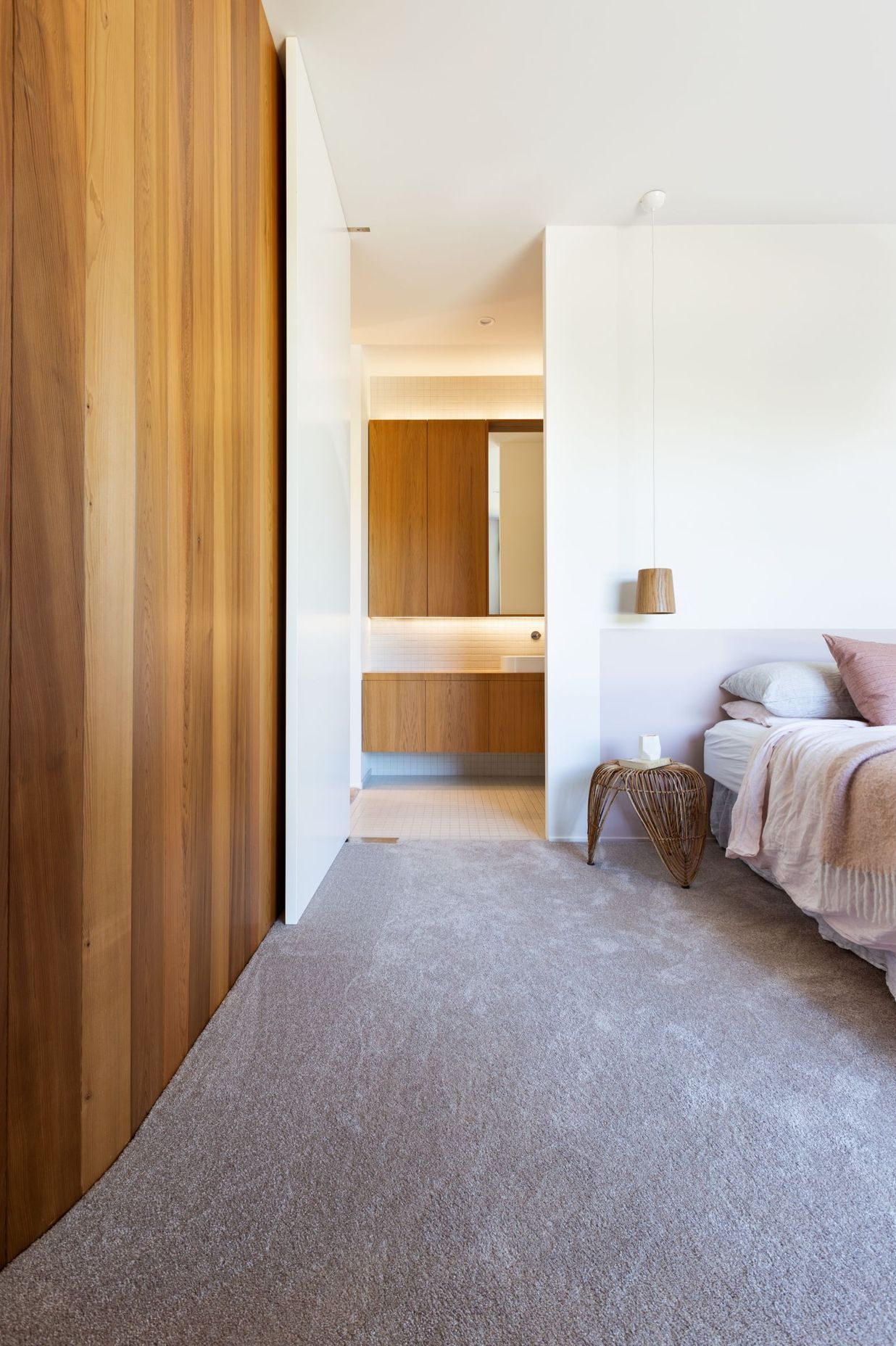 Understated colours and materials continue into the master bedroom.