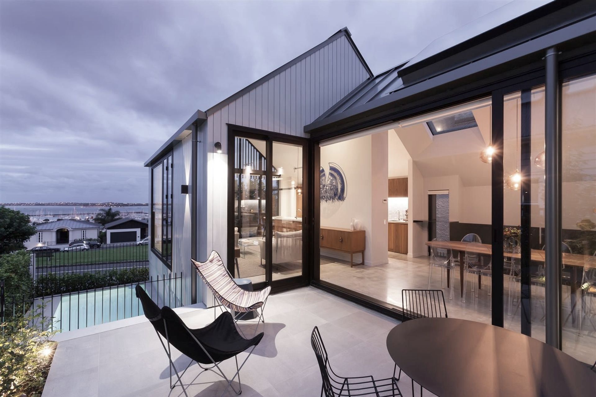 The living areas are all located on the mid-floor level and include access to a side courtyard. The swimming pool is located on the lower level next to the double garage.