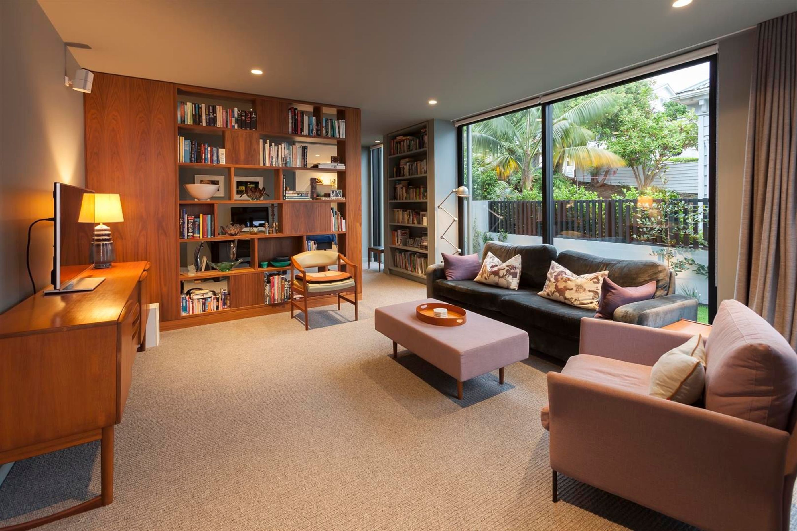 In the second living area the feeling is one of warmth and comfort, the lower ceiling height, timber accents and plush carpet all work together to create a sense of relaxed luxury.