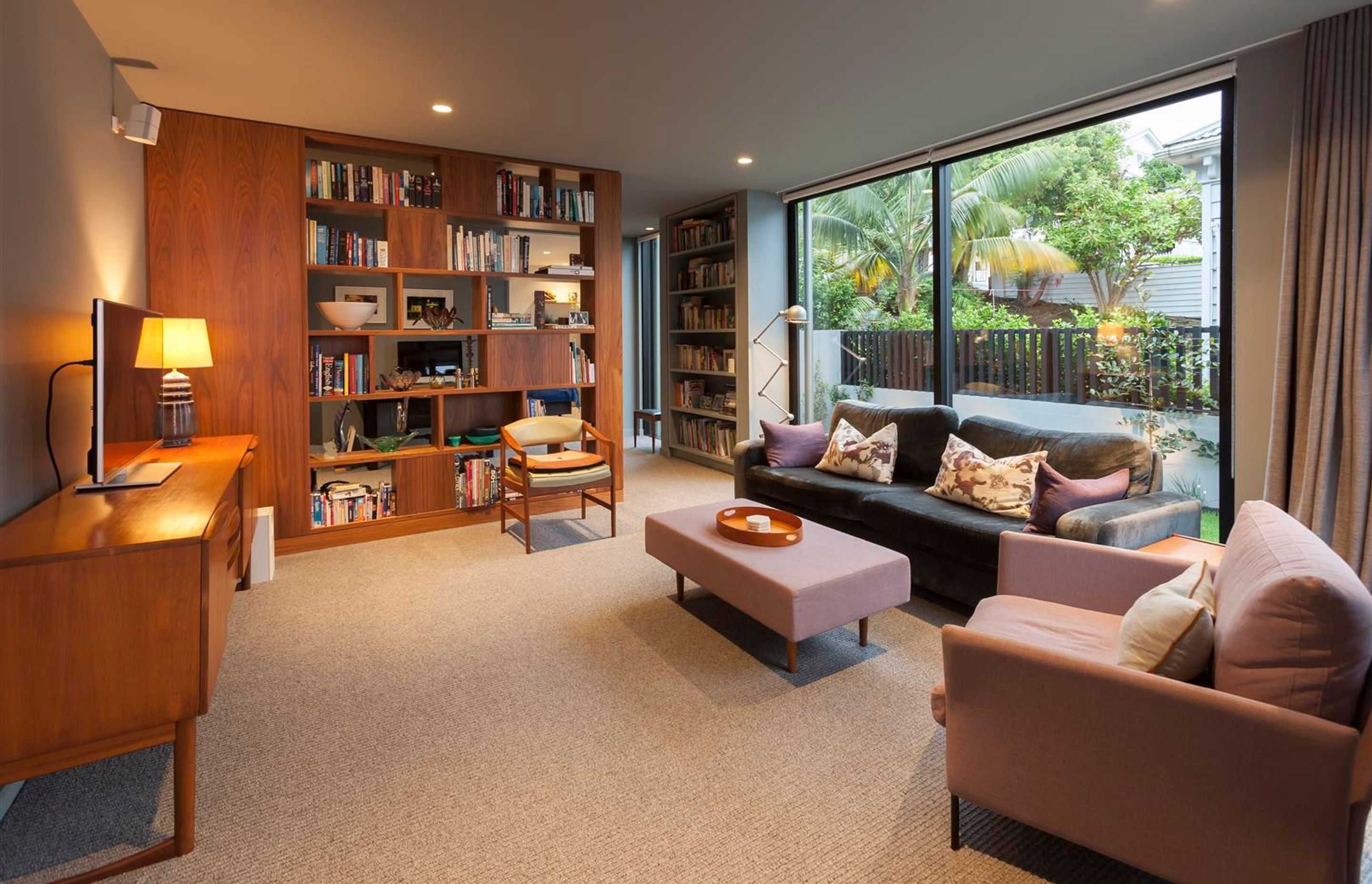 In the second living area the feeling is one of warmth and comfort, the lower ceiling height, timber accents and plush carpet all work together to create a sense of relaxed luxury.