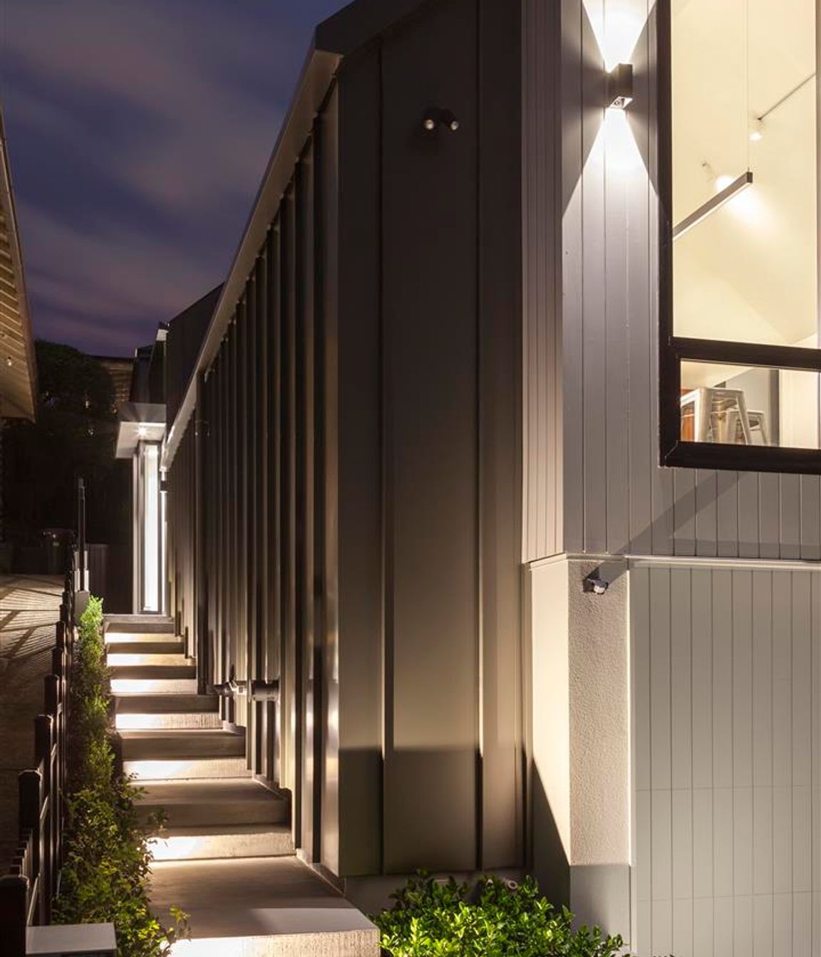 Vertical shiplap weatherboards provide a nod to the heritage nature of the area while long-run steel, which has been wrapped down the sides of the house, give it a very contemporary feel.