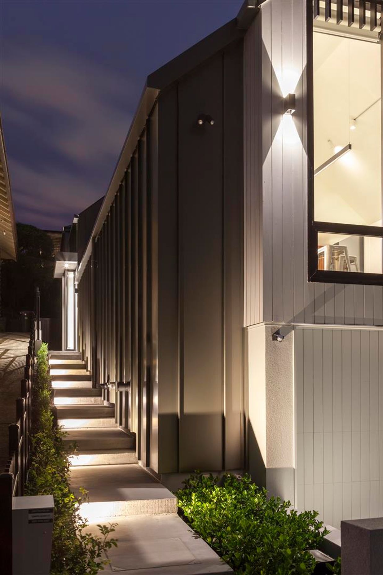 Vertical shiplap weatherboards provide a nod to the heritage nature of the area while long-run steel, which has been wrapped down the sides of the house, give it a very contemporary feel.