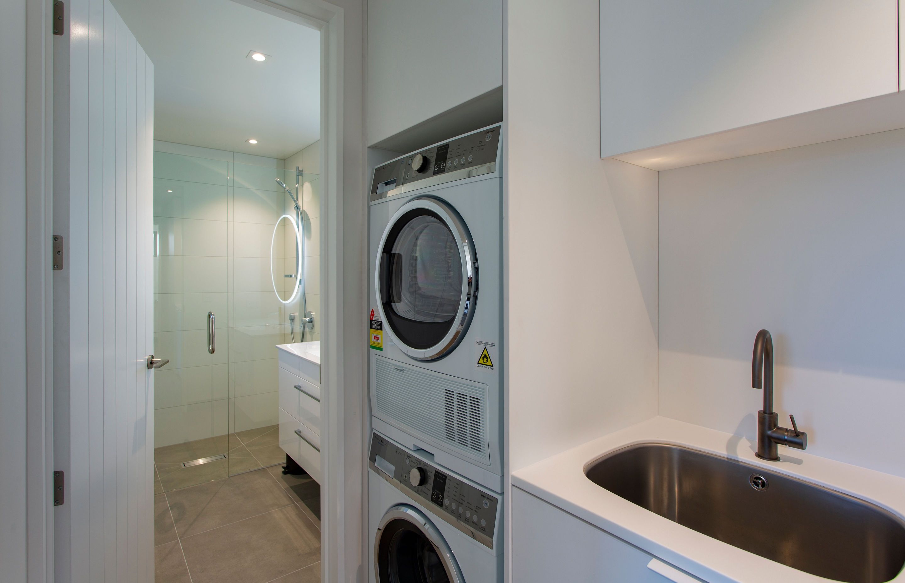 Compact laundry using F&amp;P stacker washer and dryer combo.